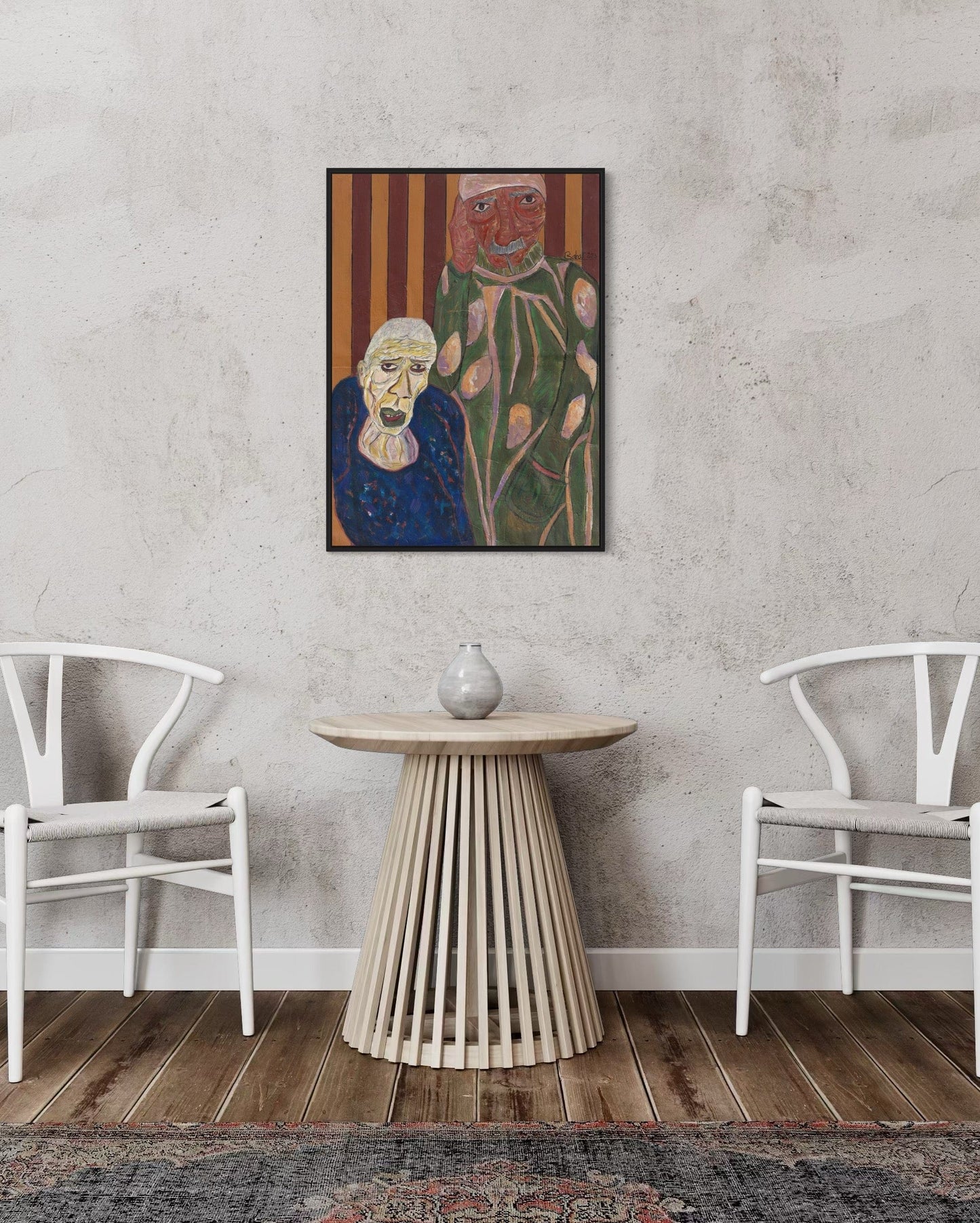Two white chairs and a wooden table in a room with a painting of two faces on the wall.