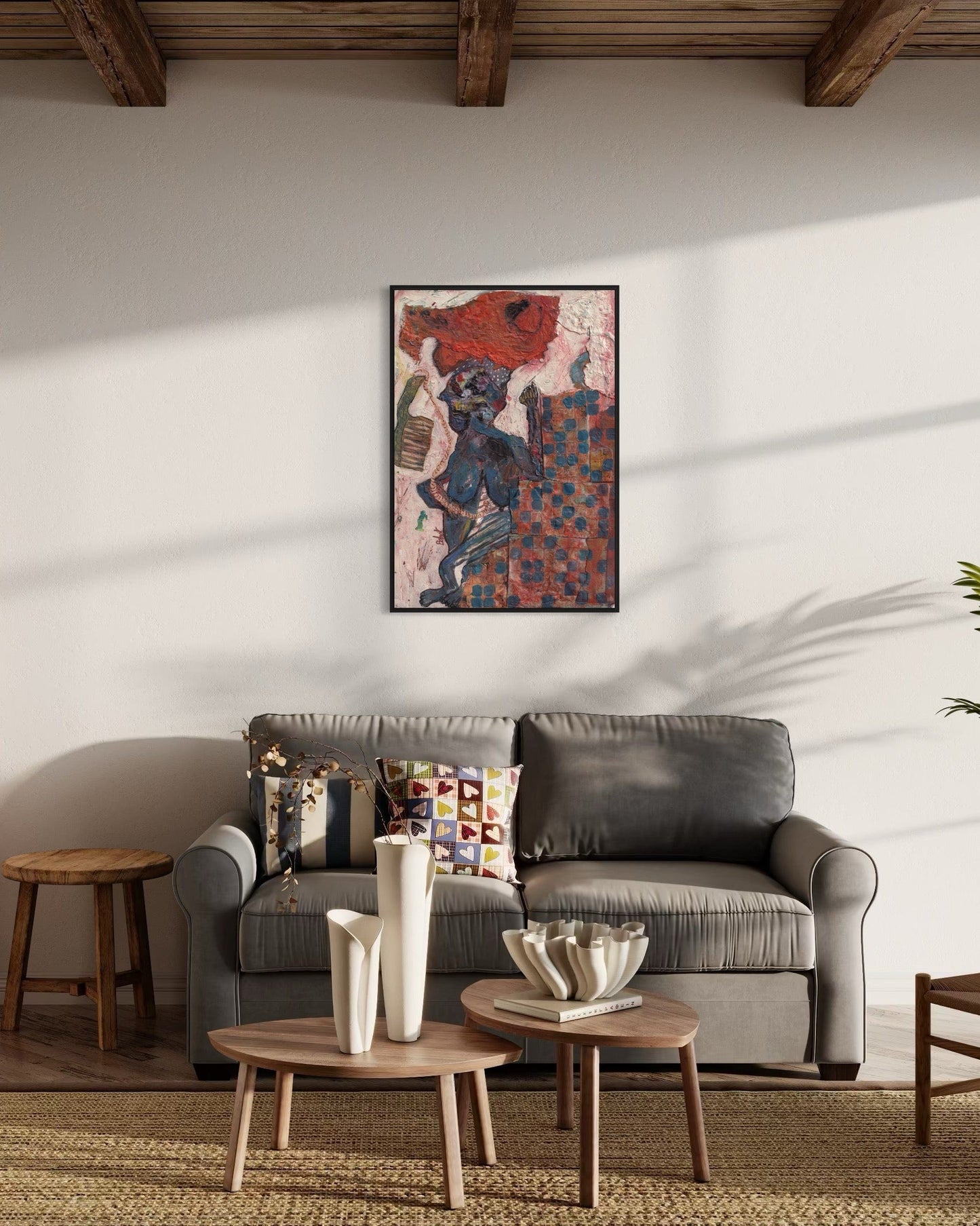 Living room with a gray sofa, wooden coffee table, and colorful artwork on the wall.