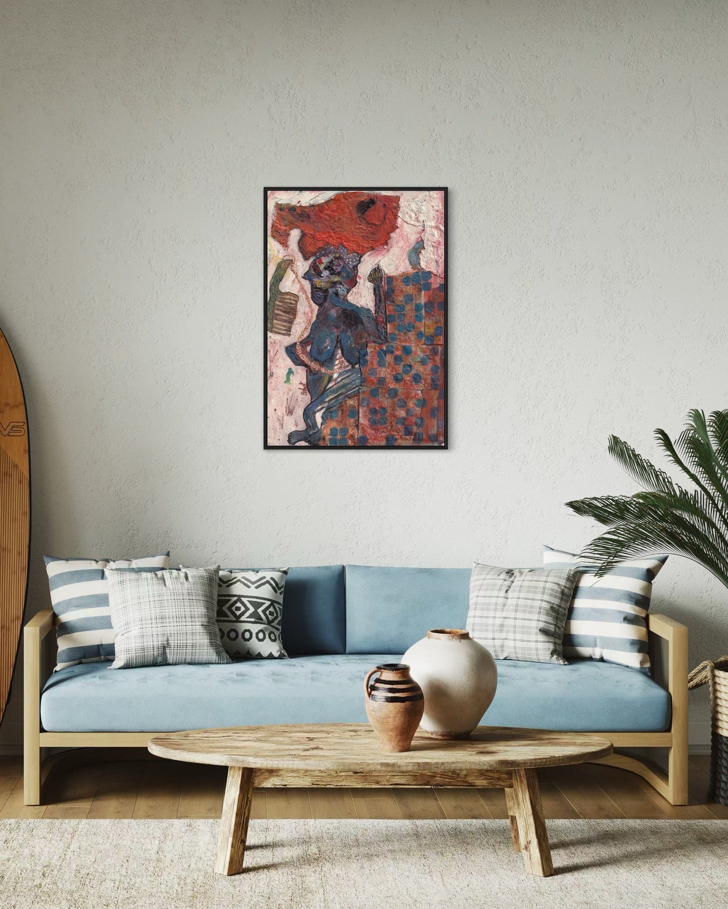 Living room with a blue sofa, decorative pillows, a wooden coffee table, and a colorful abstract painting on the wall.