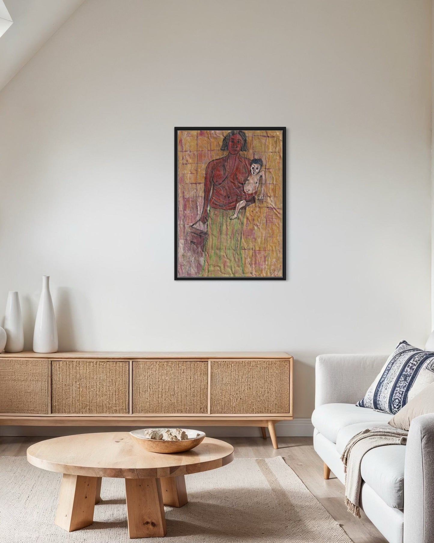 Living room with a painting of a woman holding a child on the wall, a wooden coffee table, and a sofa.