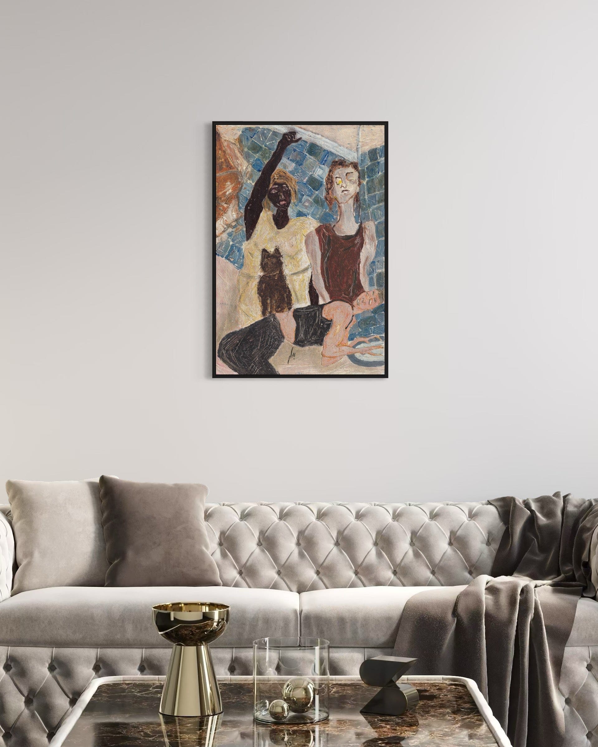 Framed artwork of two figures on a wall above a gray sofa in a living room.