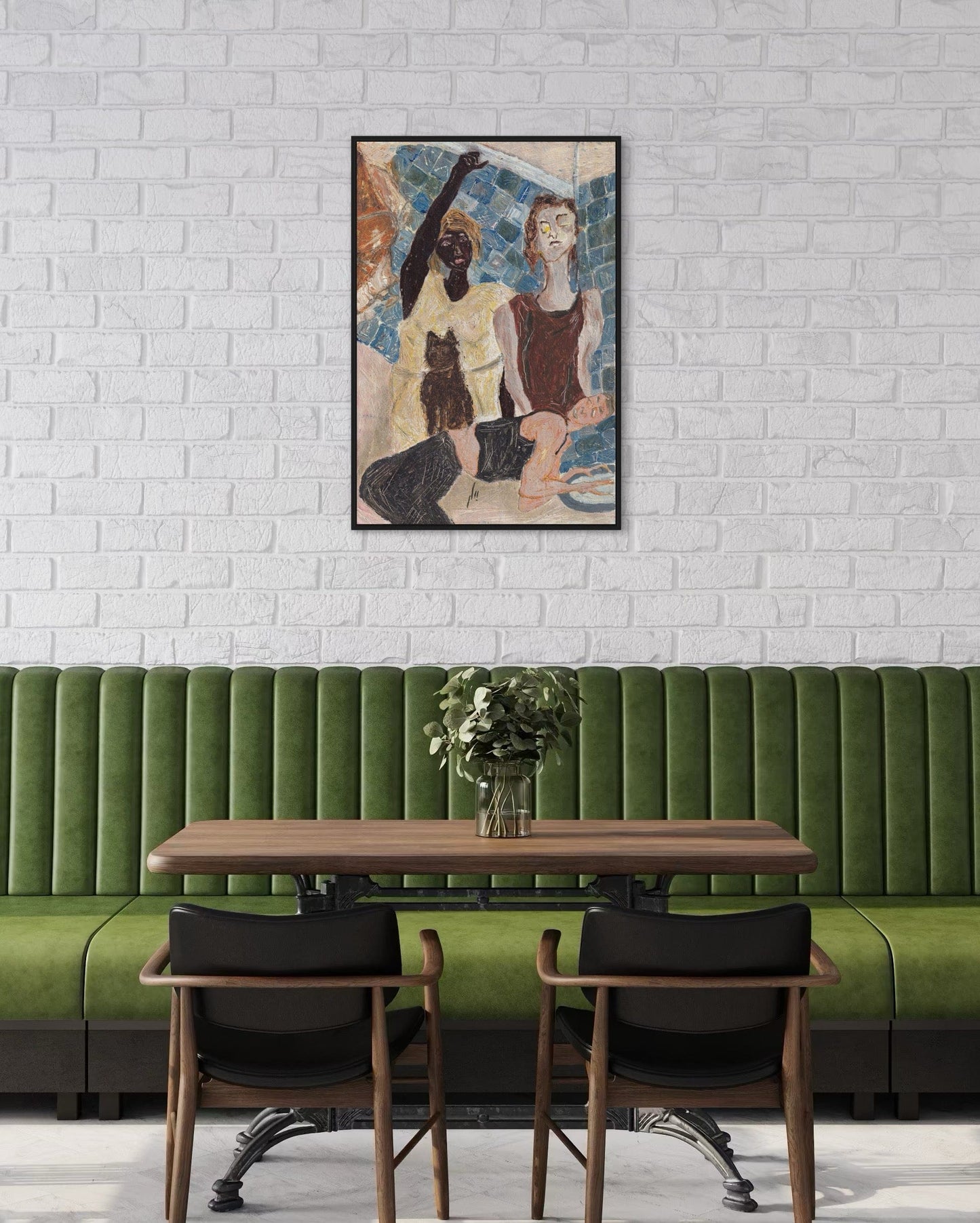 Green booth with wooden table and chairs against a white brick wall with a framed artwork.