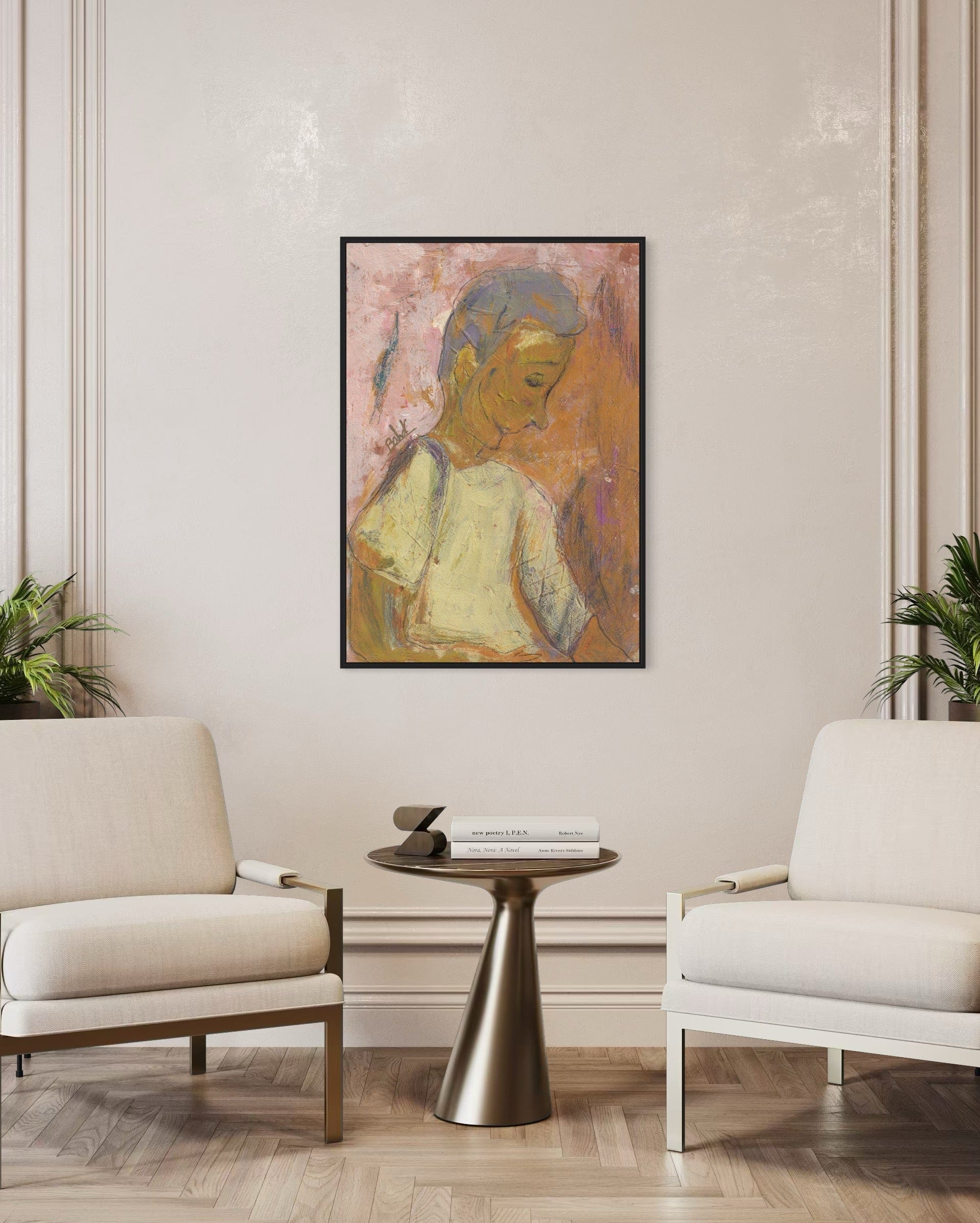 Framed artwork of a woman on a wall above a table and chairs in a room.