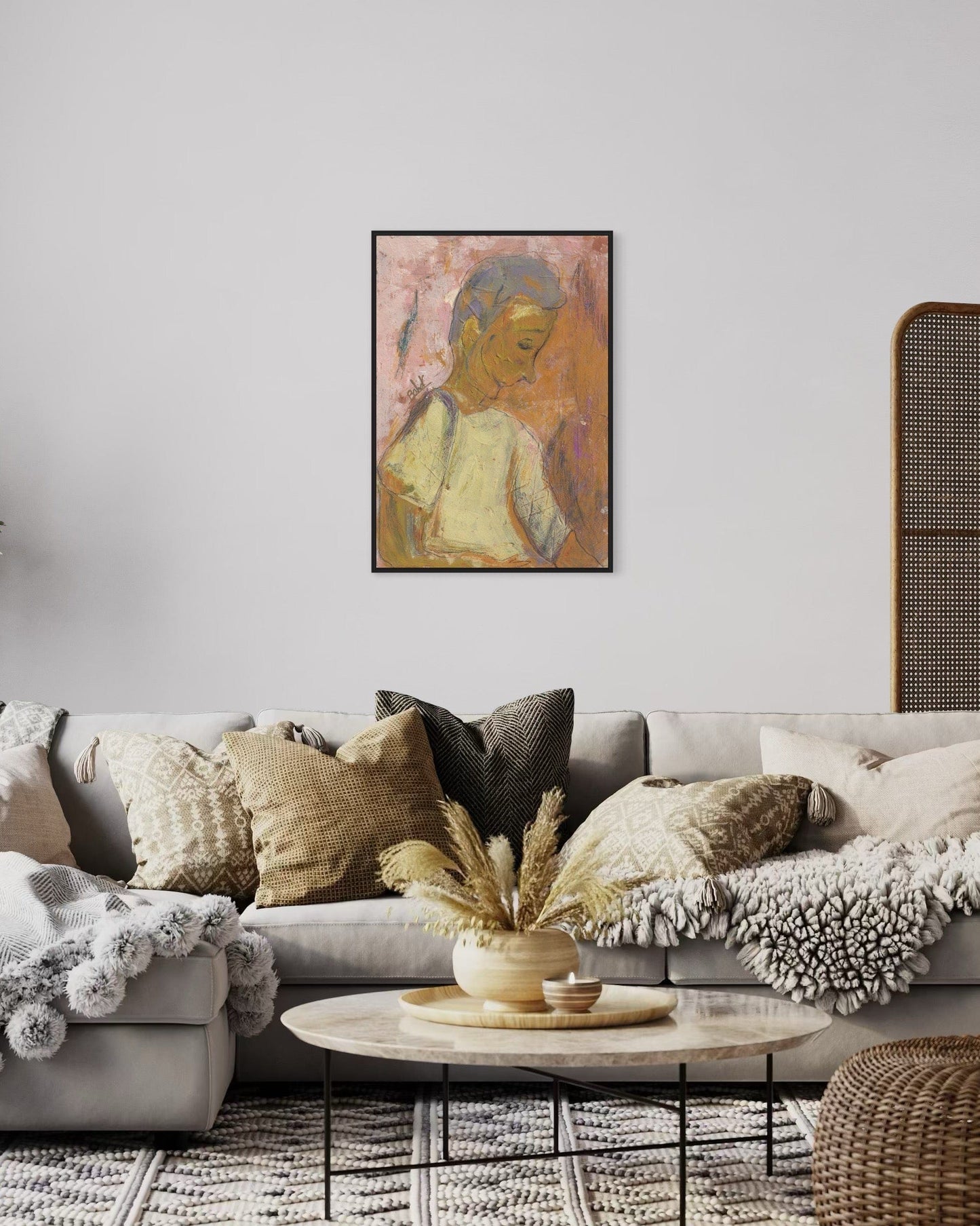 Living room with a gray sofa, decorative pillows, a coffee table, and a framed painting on the wall.