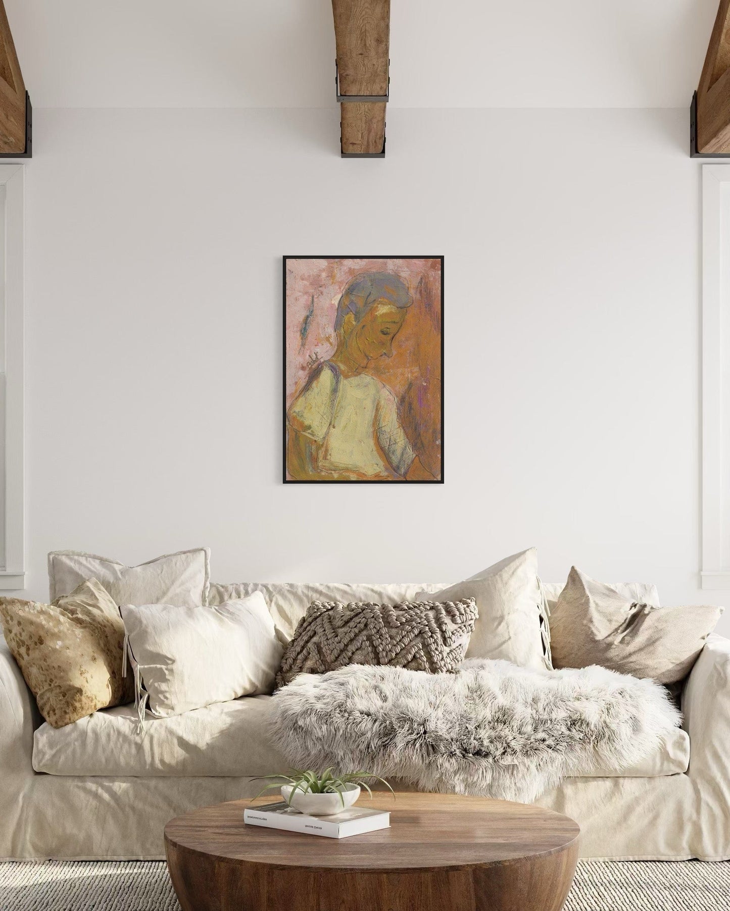 Living room with a beige sofa, wooden coffee table, and framed artwork on the wall.