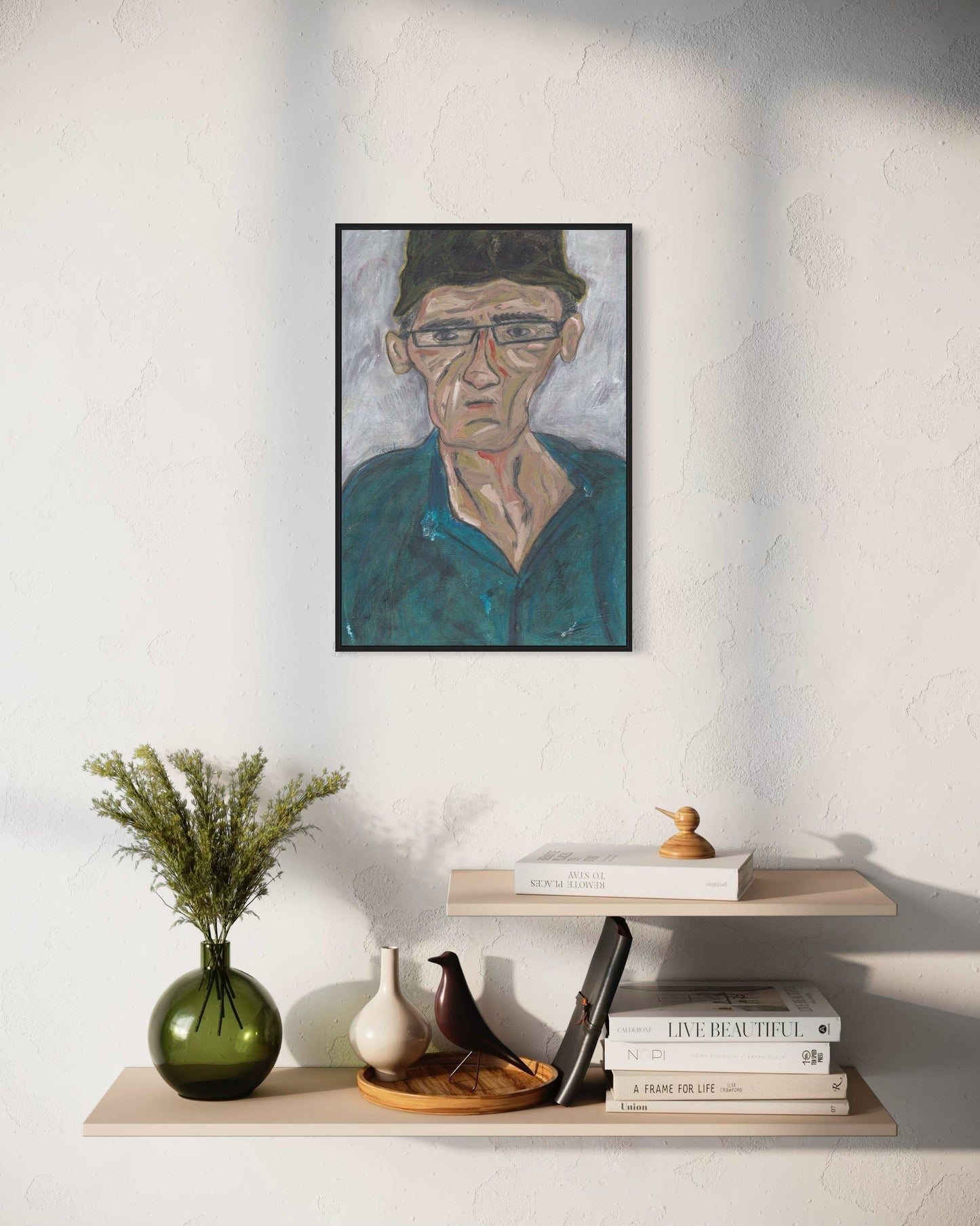 Framed portrait on a wall above a shelf with decorative items