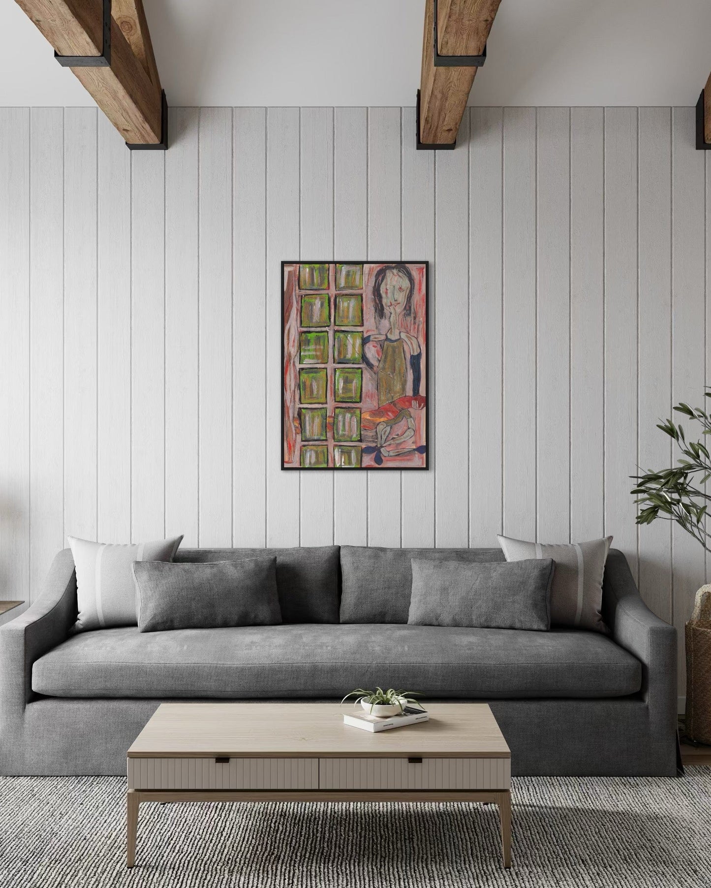 Gray sofa in a living room with a colorful painting on the wall.