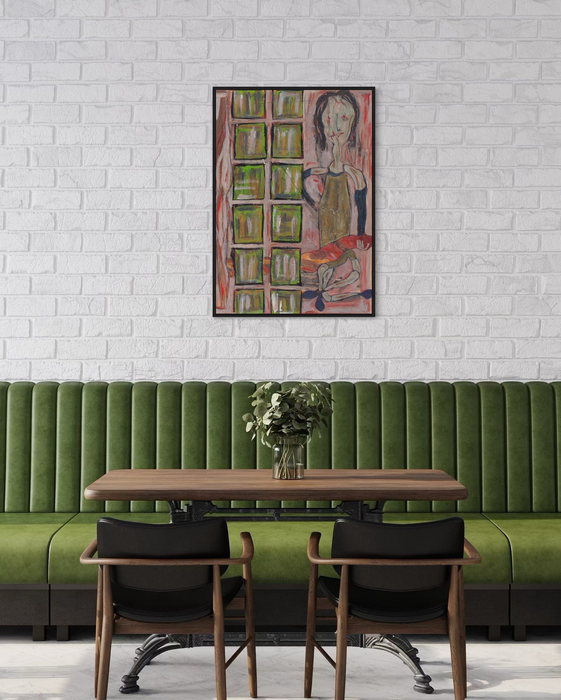 Green booth with wooden table and chairs against a white brick wall with a colorful painting.