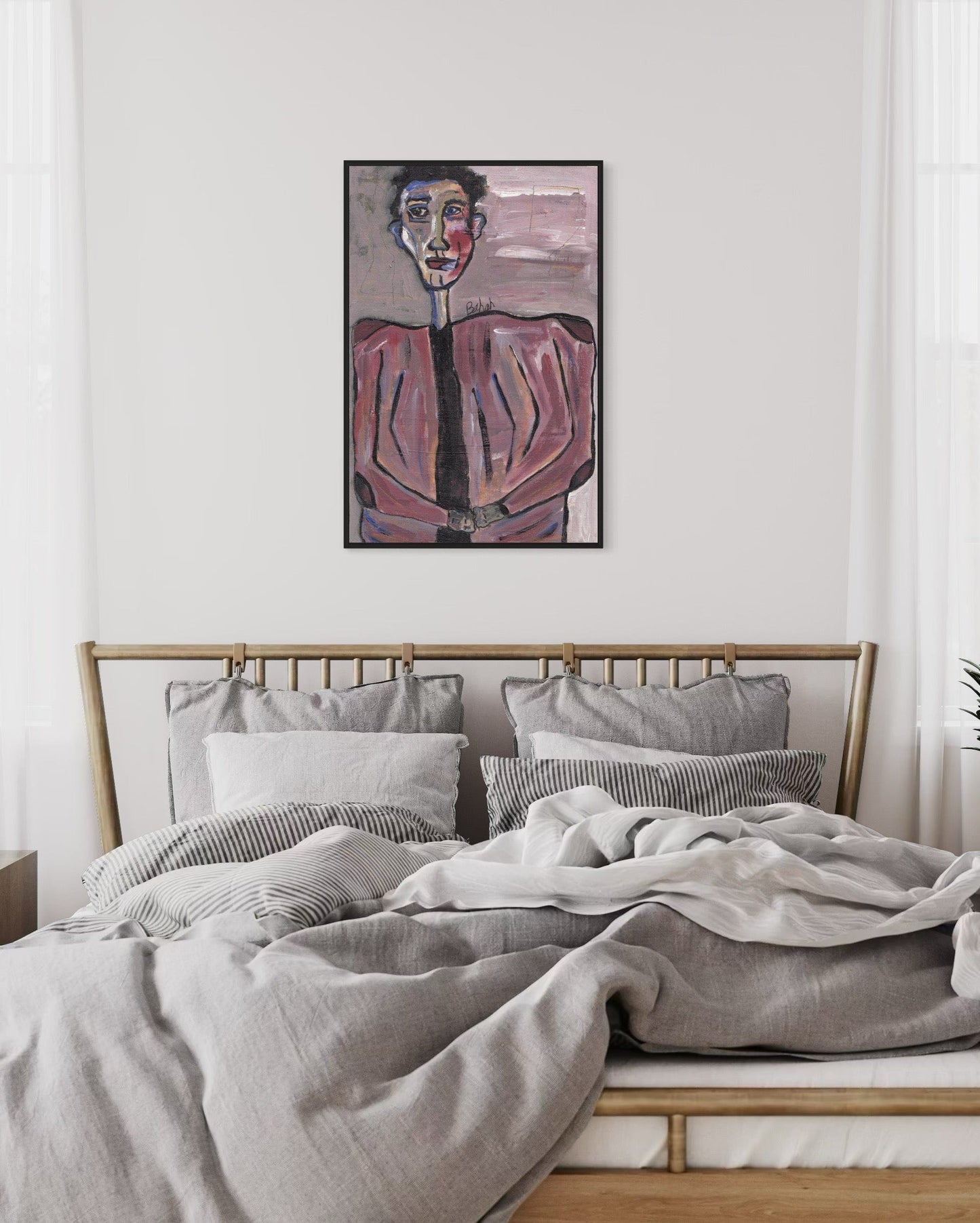 Bedroom with a bed and wall art on a white wall