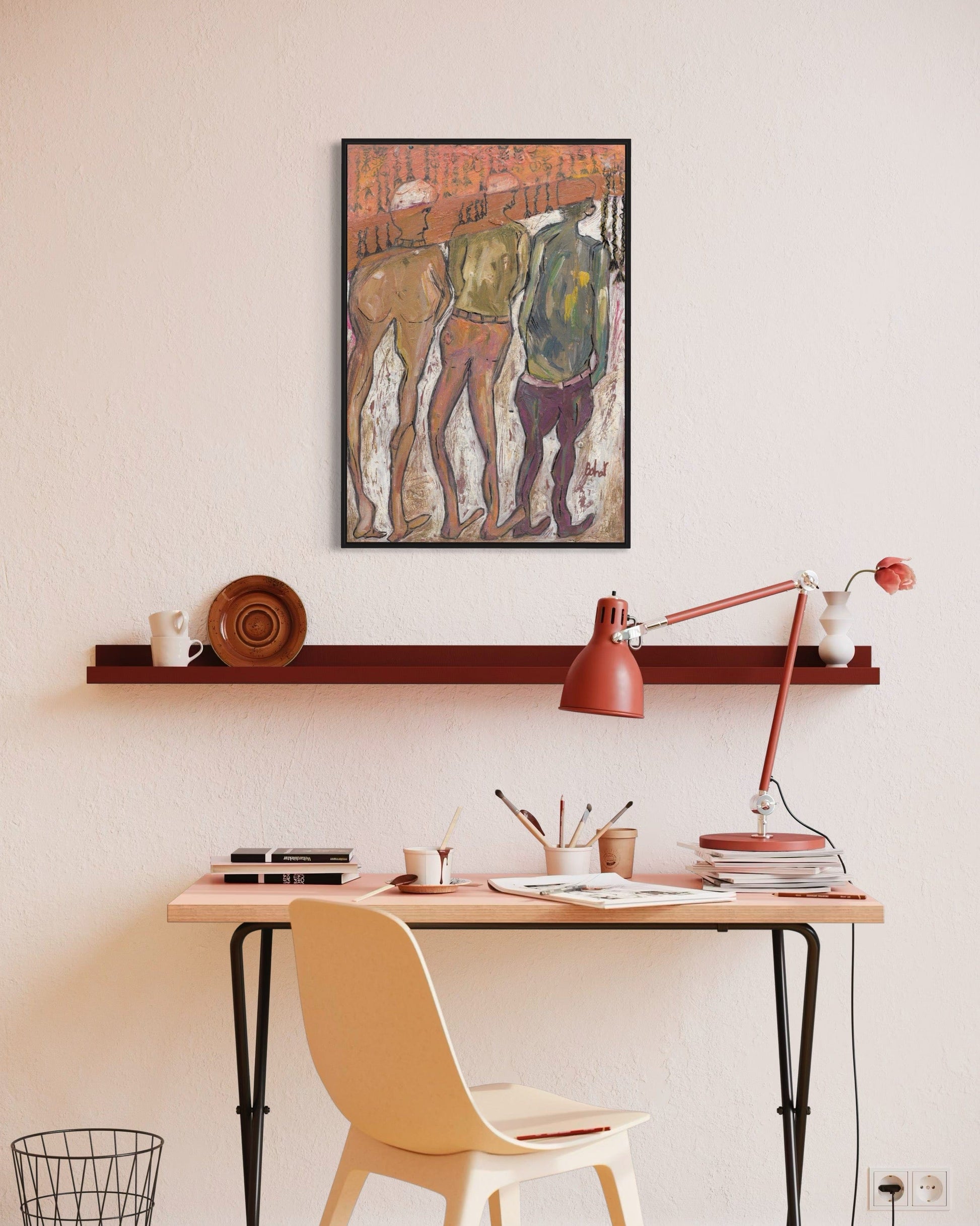 Home office with a desk, chair, lamp, and wall art.