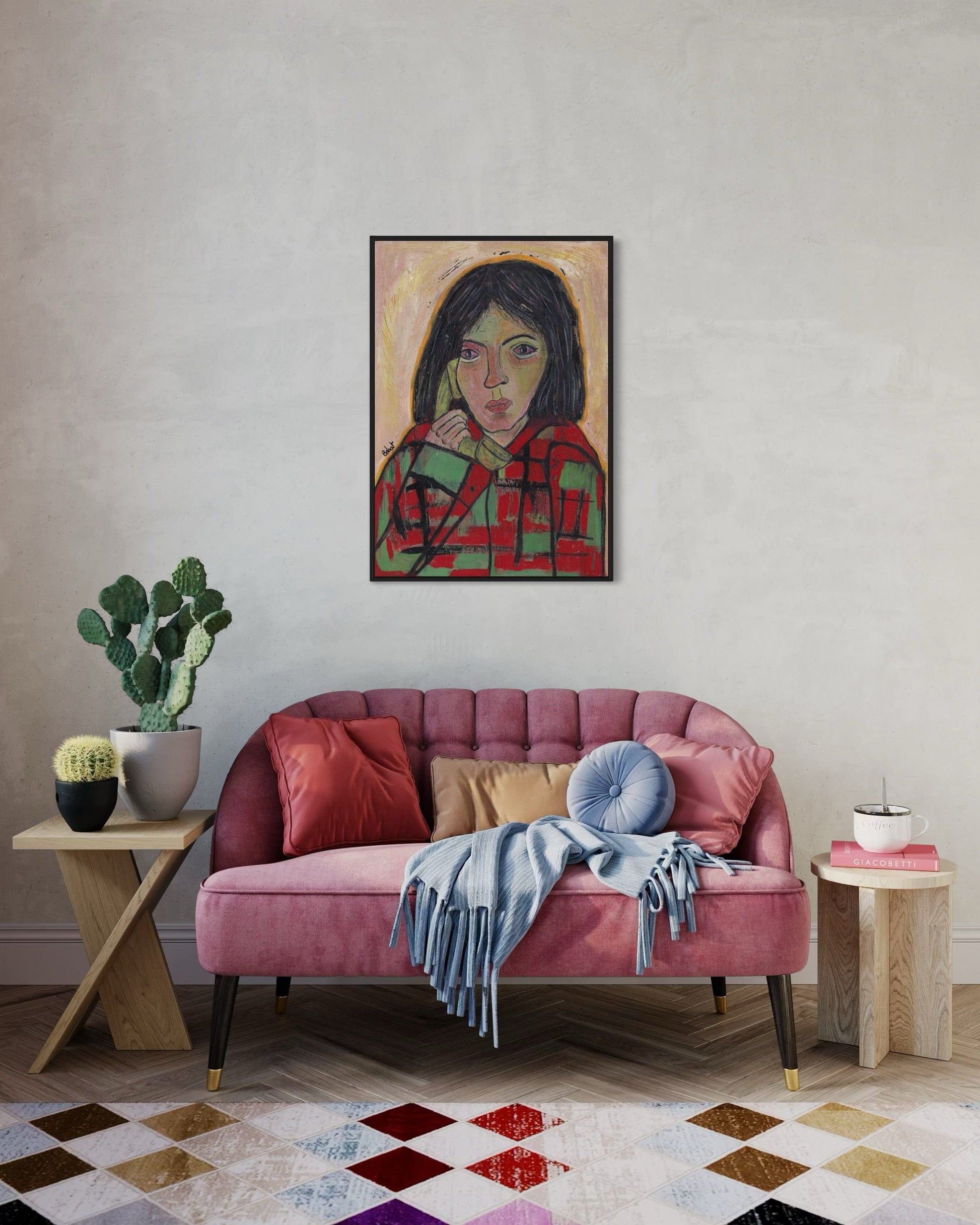 Living room with a pink sofa, colorful rug, and framed artwork on the wall.