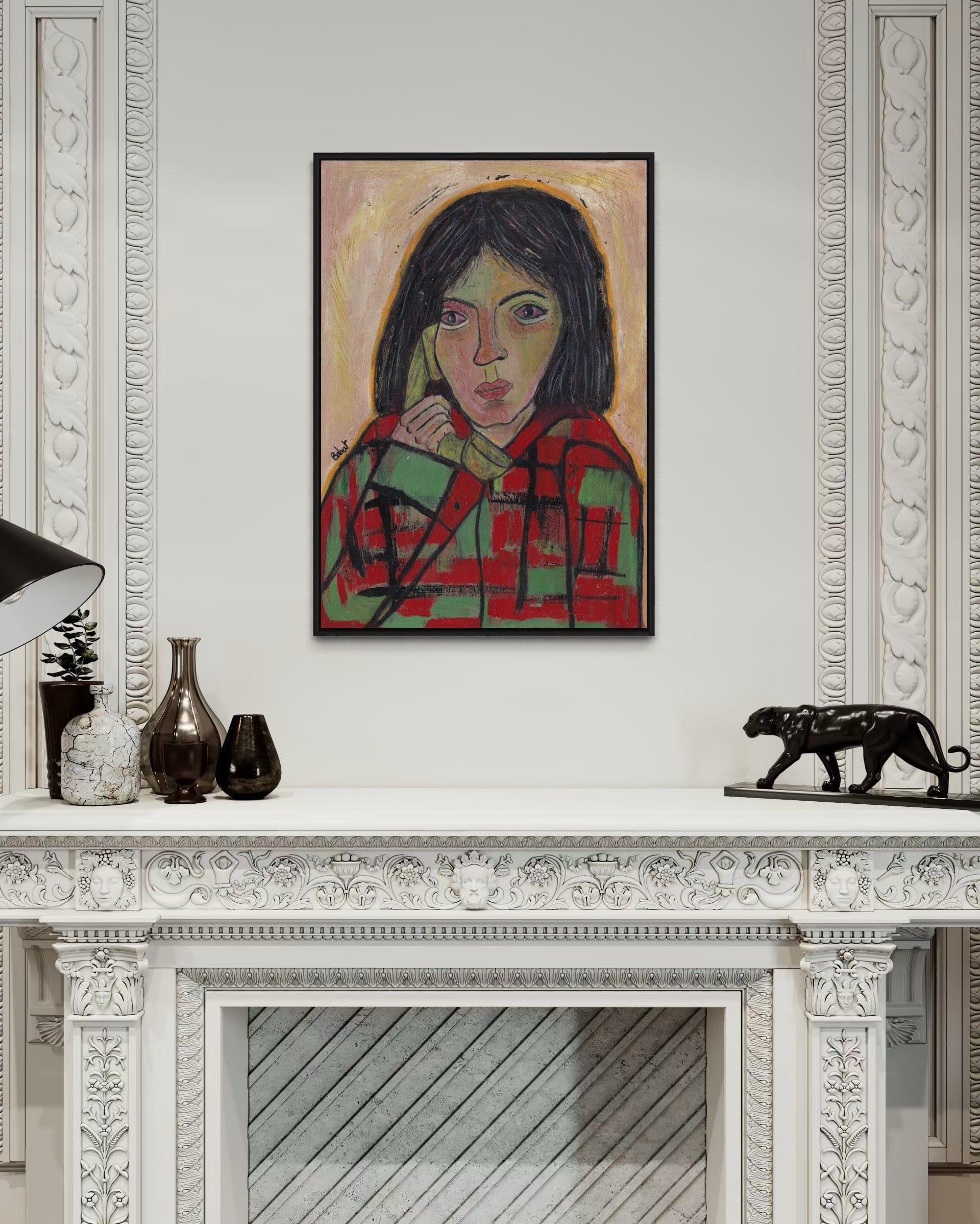 Framed artwork of a woman's portrait on a wall above a fireplace.