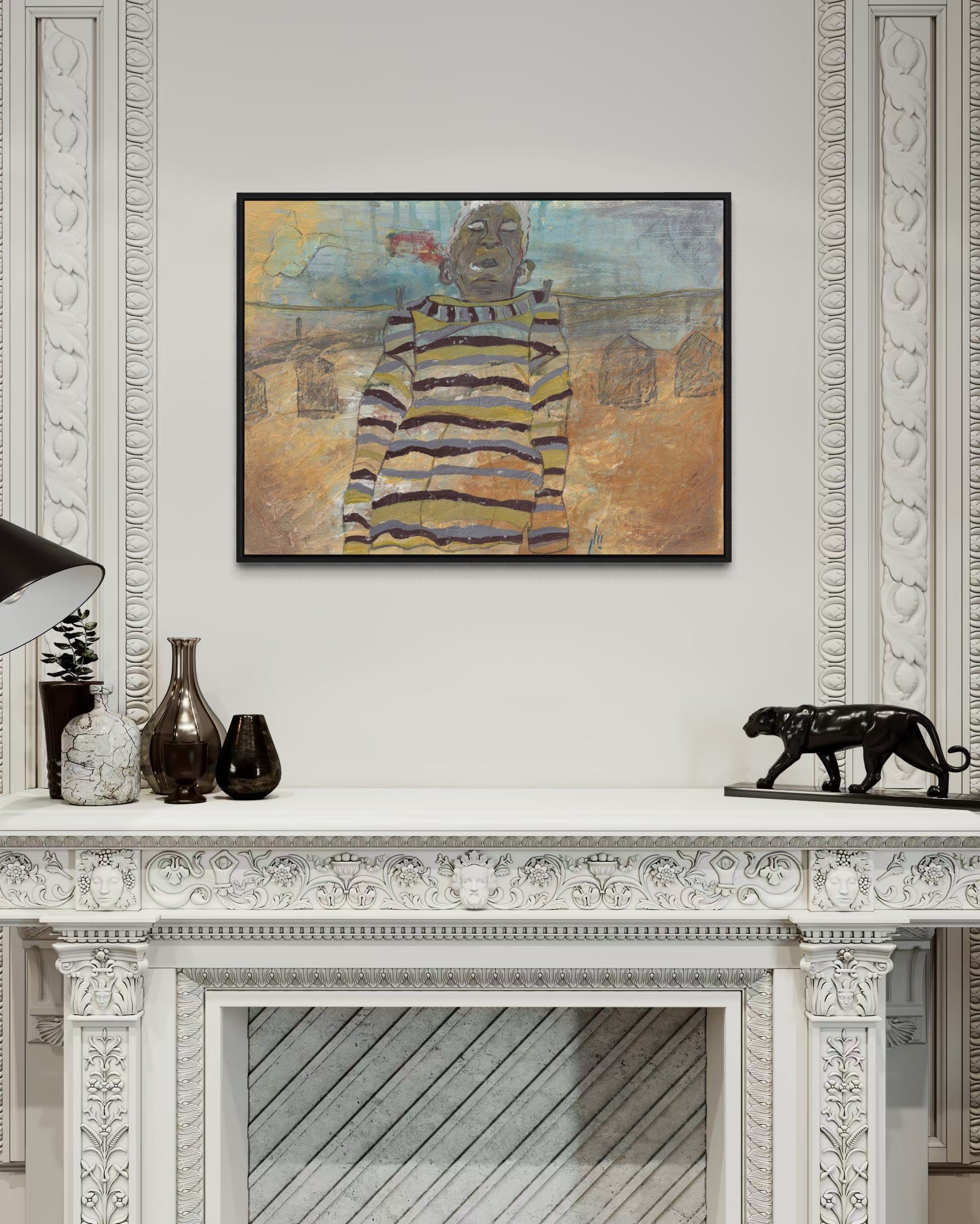 Framed artwork on a wall above a decorative fireplace mantle.