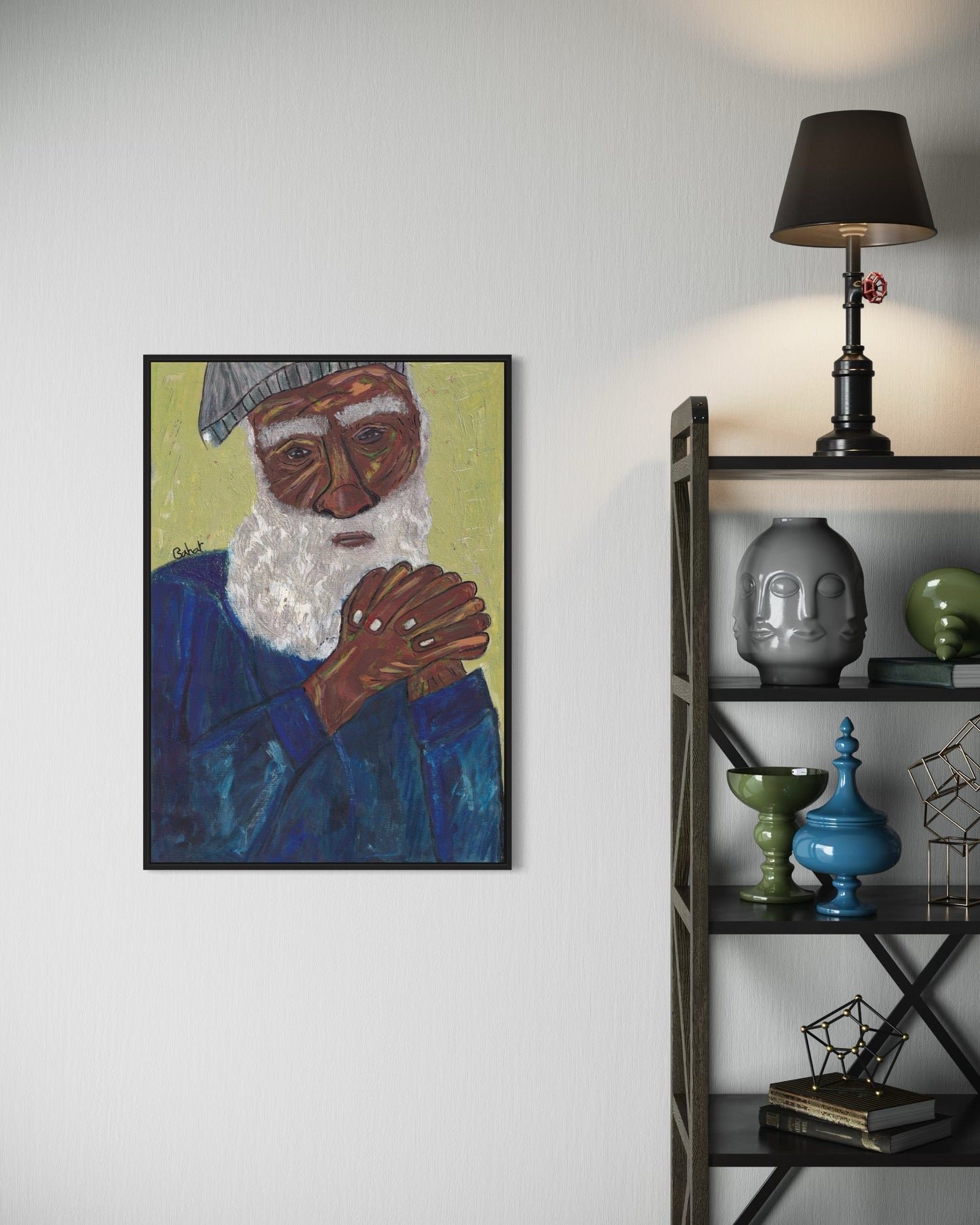 Framed artwork of a man with a beard on a wall next to a shelf with decorative items.