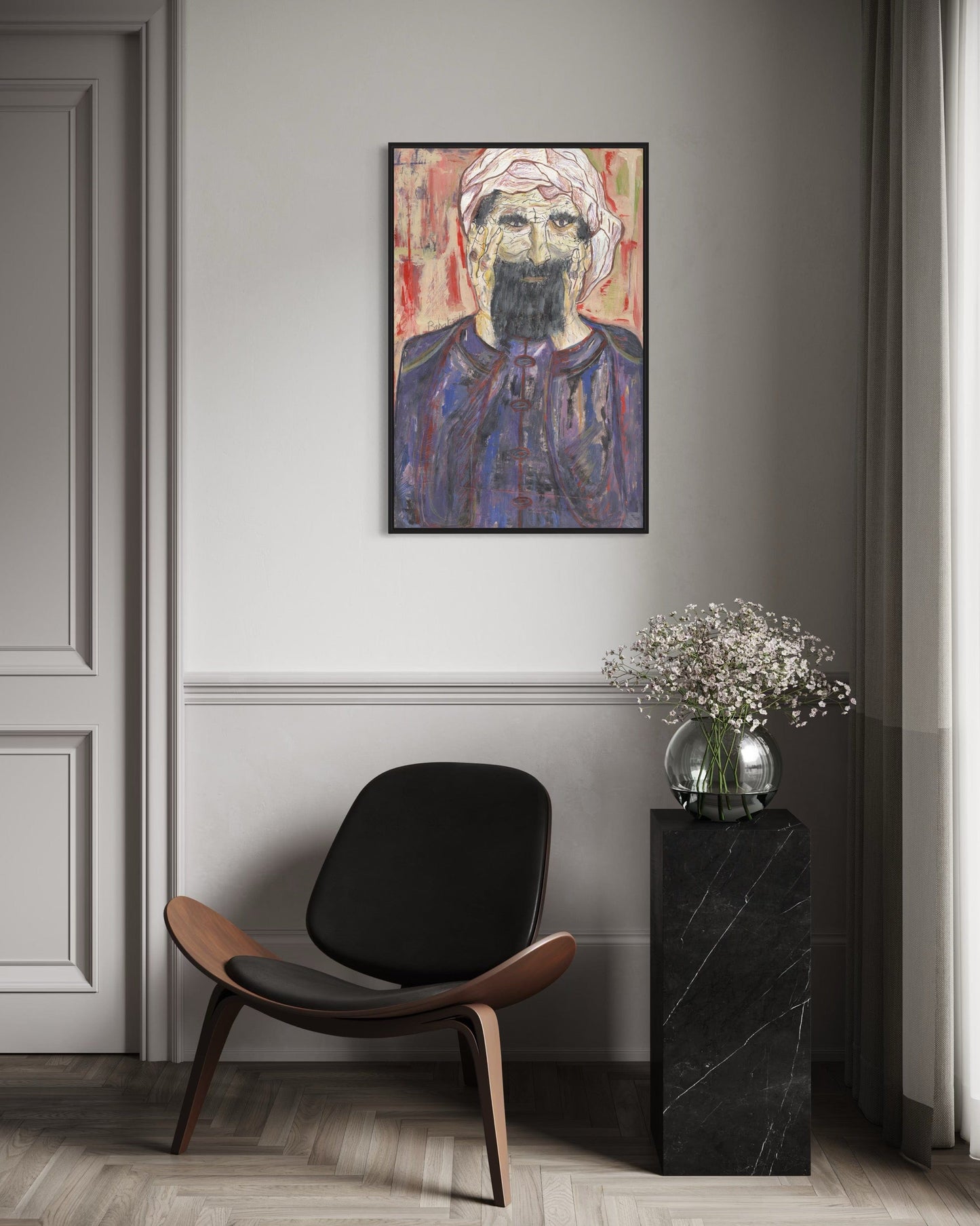 Modern interior with a black chair, side table, and abstract portrait on the wall.