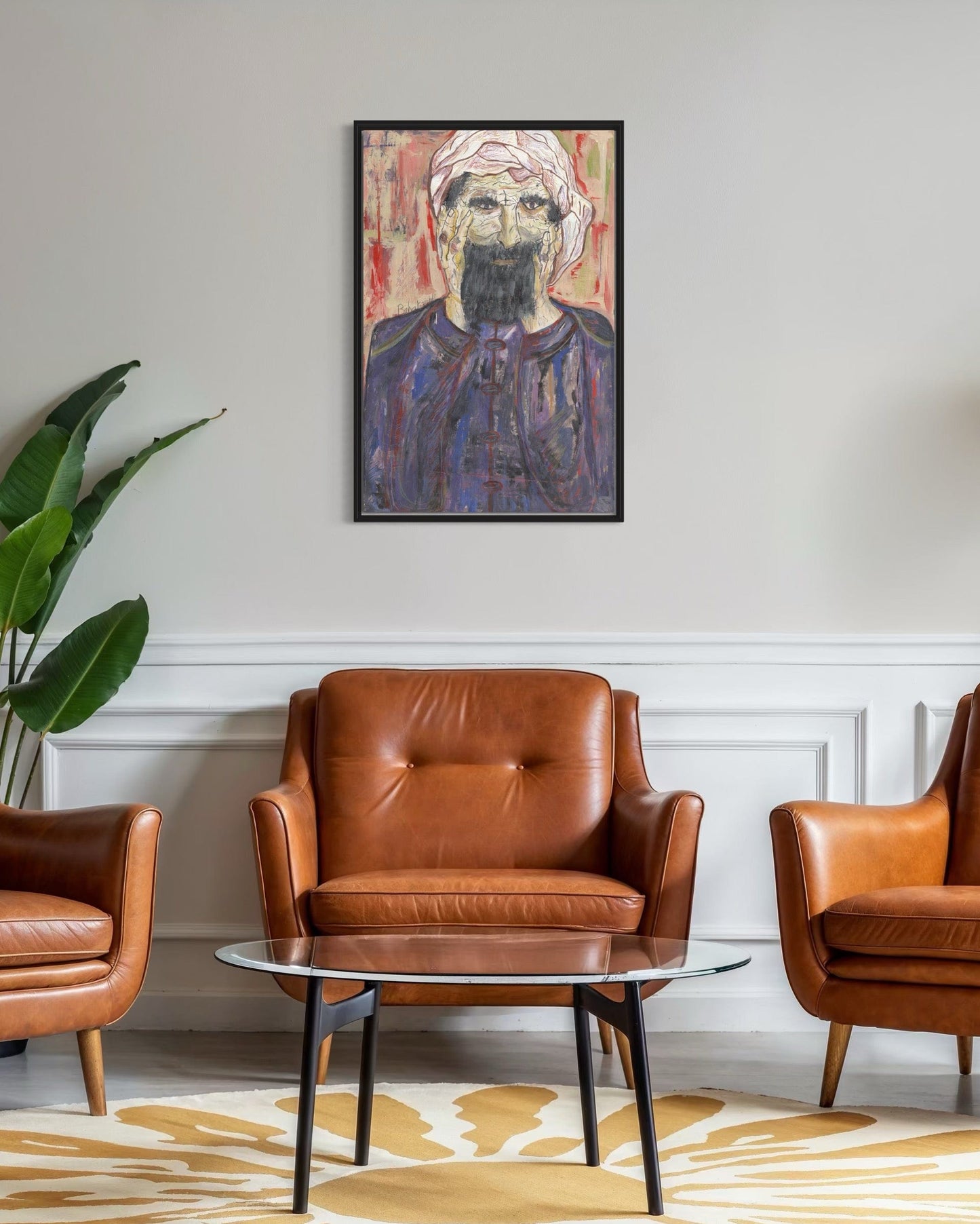 Living room with brown leather chairs, a glass coffee table, and a framed portrait on the wall.