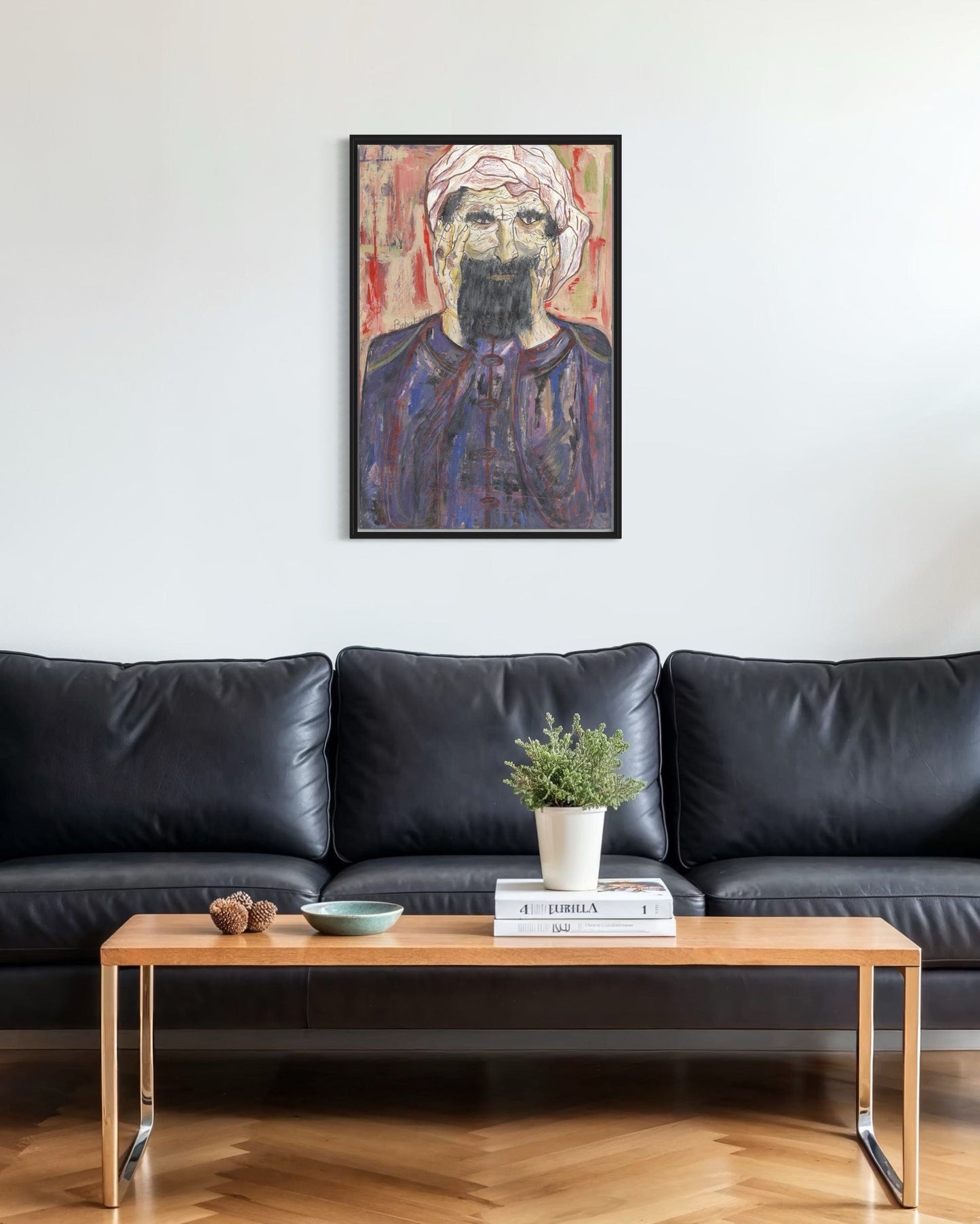 Living room with a black leather sofa, wooden coffee table, and a framed portrait on the wall.