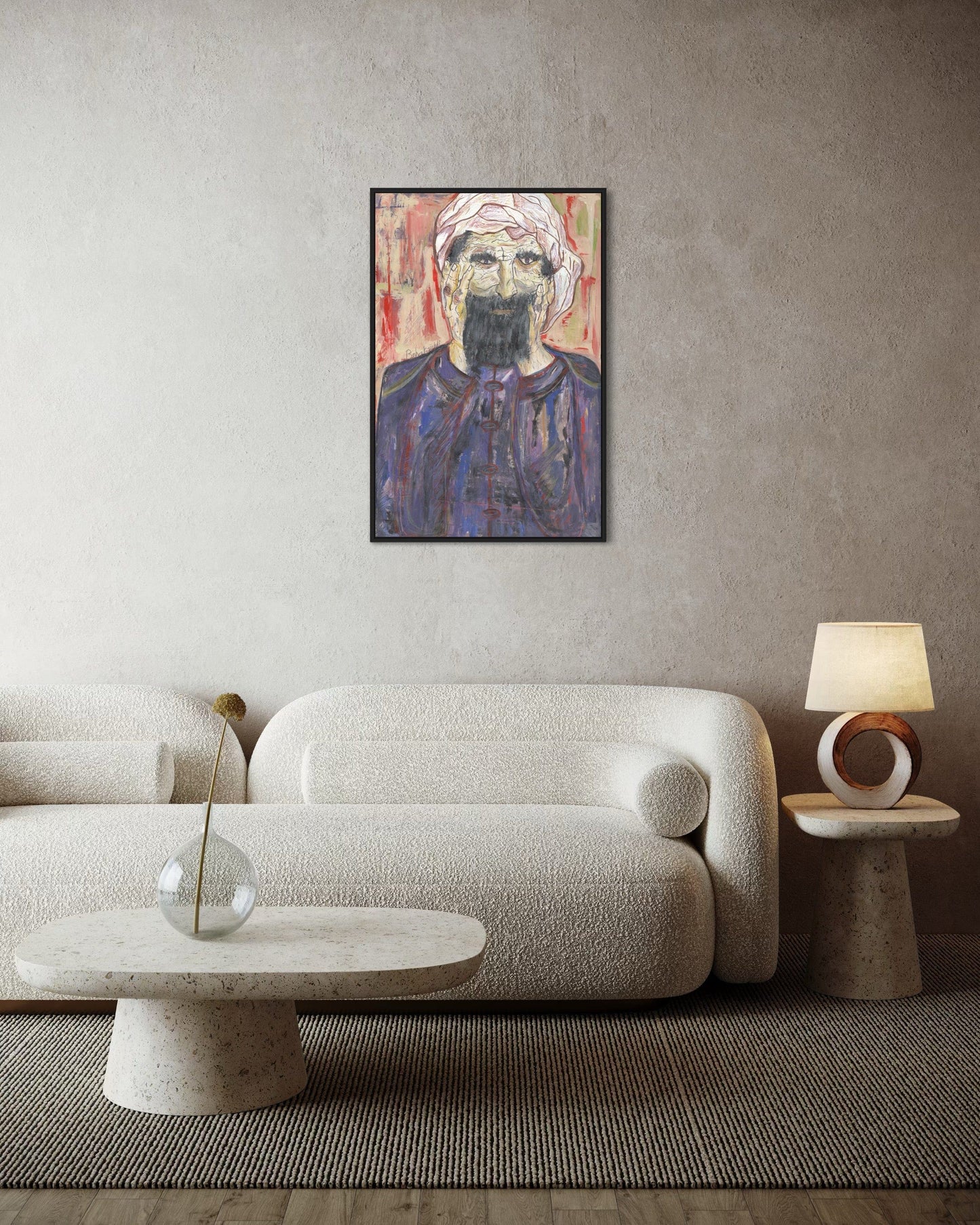 Modern living room with a textured sofa, coffee table, and lamp against a neutral wall with a framed portrait.