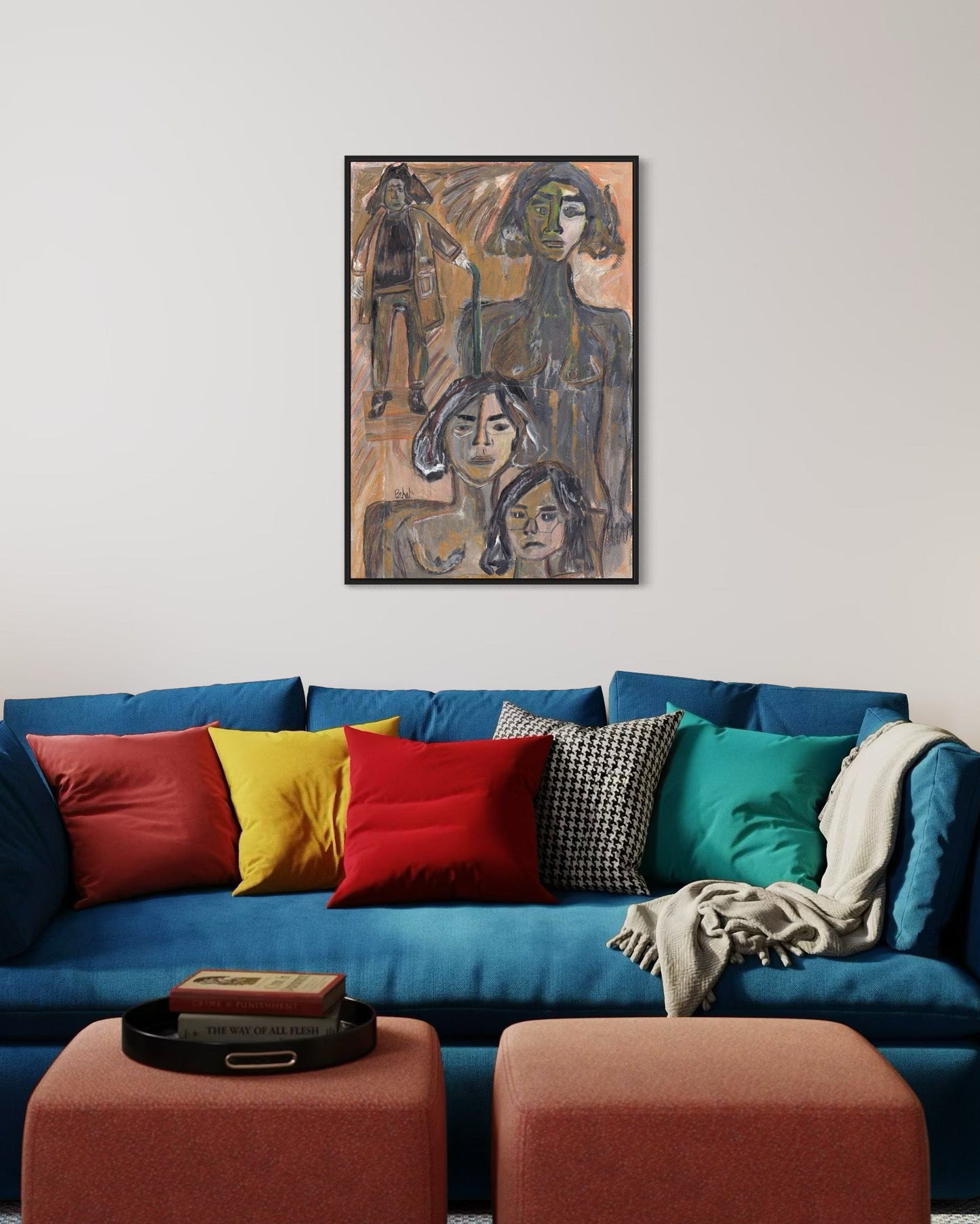 Colorful sofa with patterned cushions and a painting above in a living room.