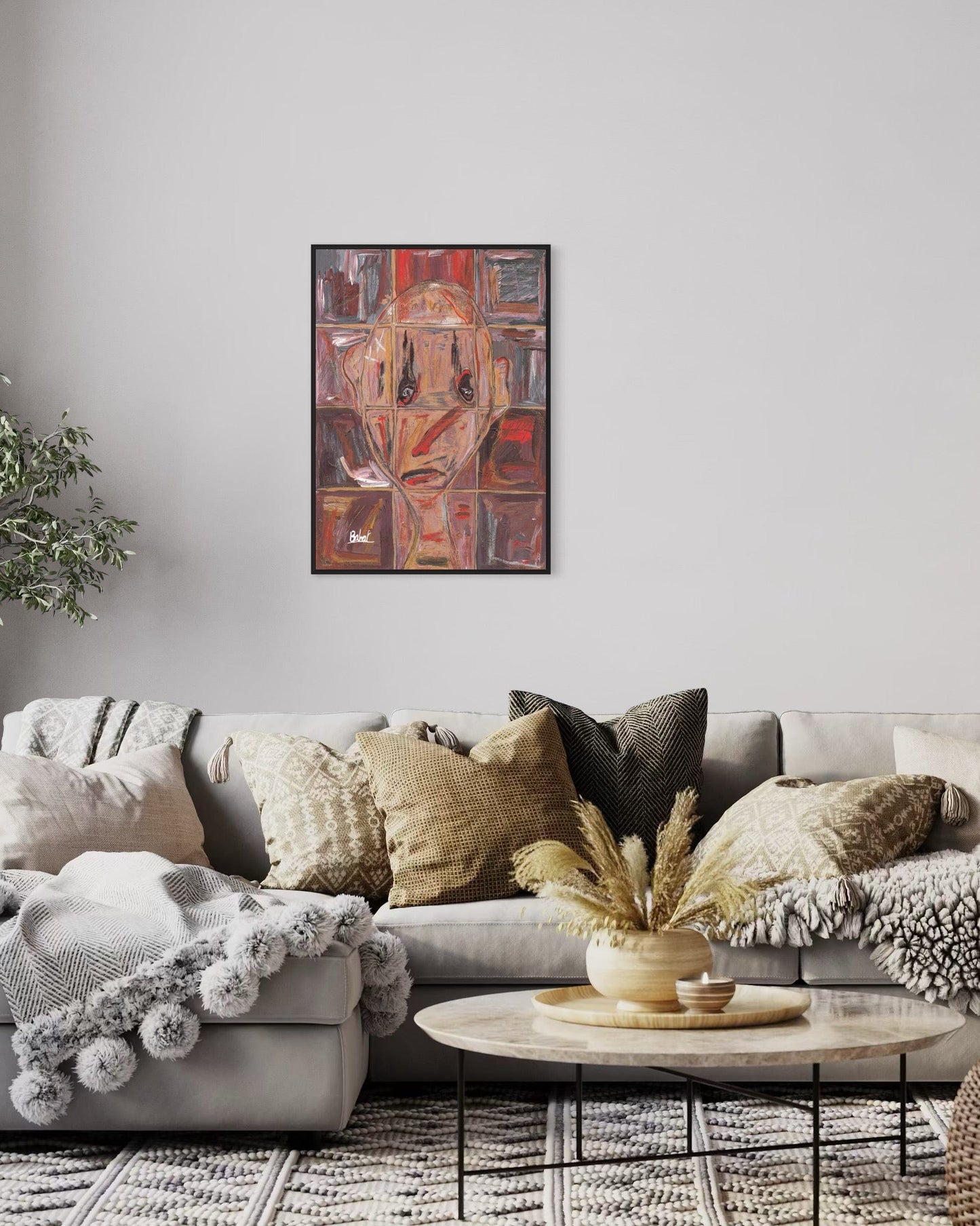 Living room with a gray sectional sofa, decorative pillows, a coffee table, and a framed abstract painting on the wall.