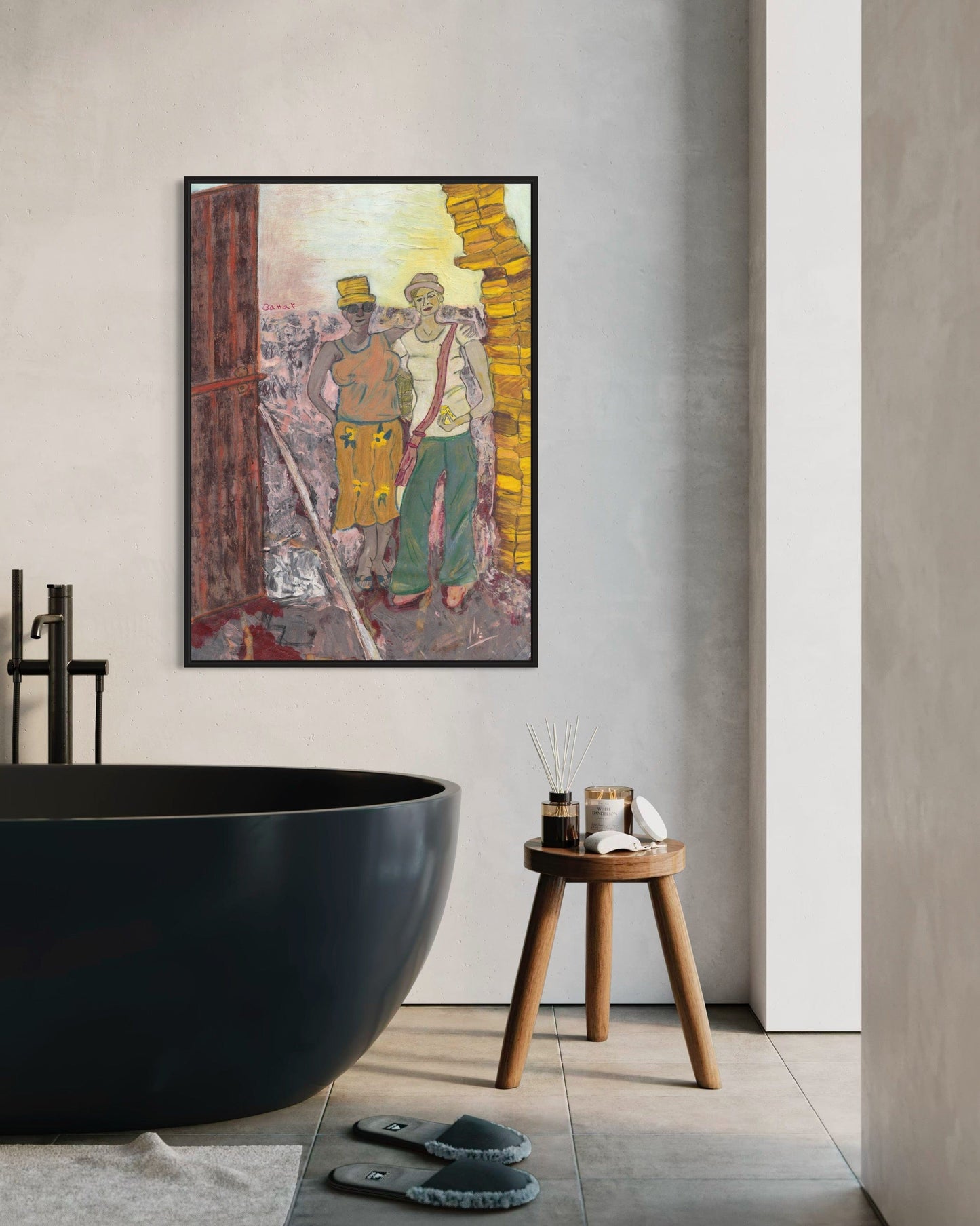 Modern bathroom interior with a large black freestanding bathtub, wooden stool, and abstract art on the wall.