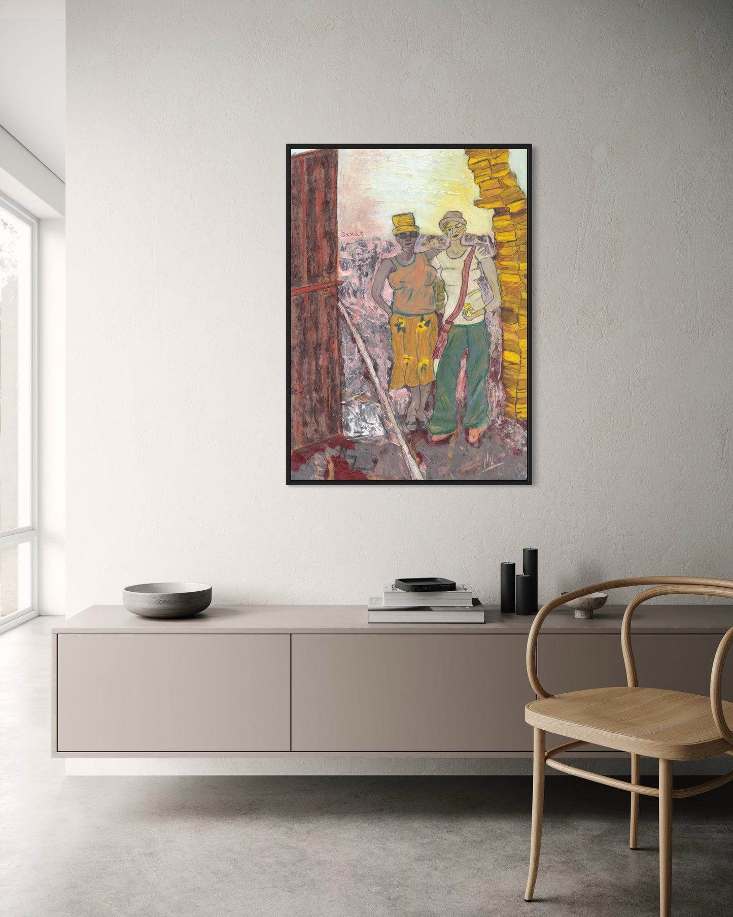 Framed artwork on a wall in a modern room with a chair and cabinet.