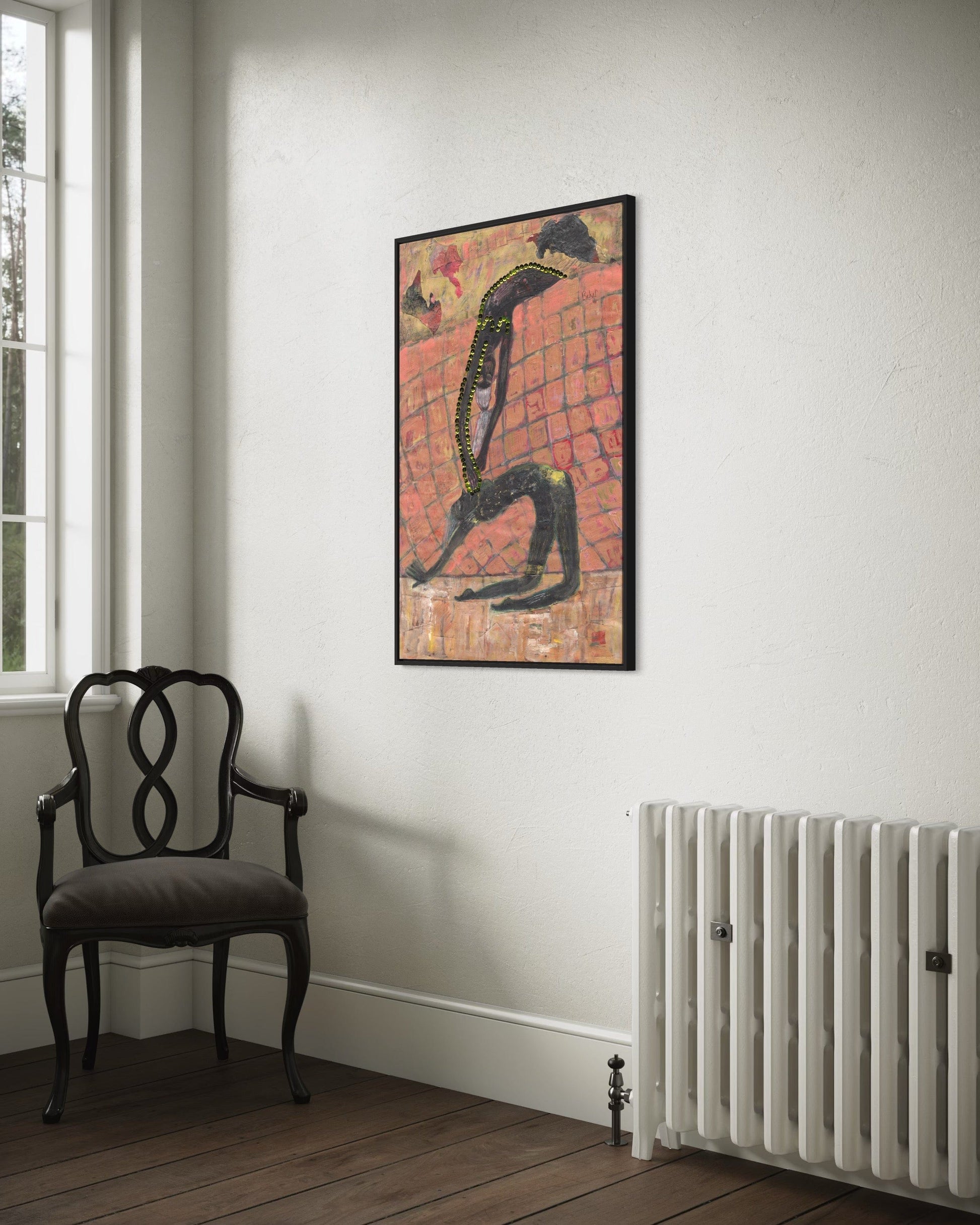 Framed abstract artwork on a wall above a radiator and chair.