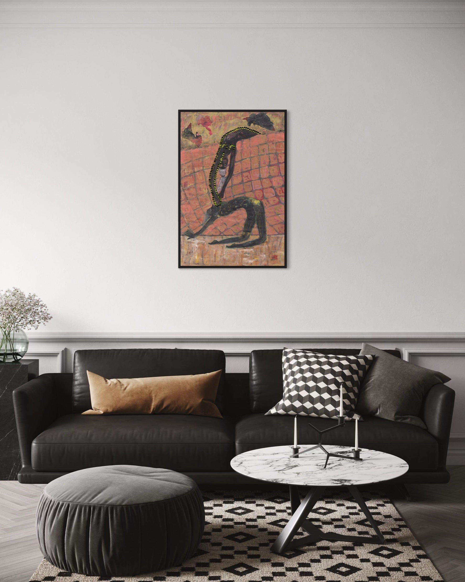 Modern living room with a black sofa, coffee table, and decorative pillows, featuring a framed artwork on the wall.