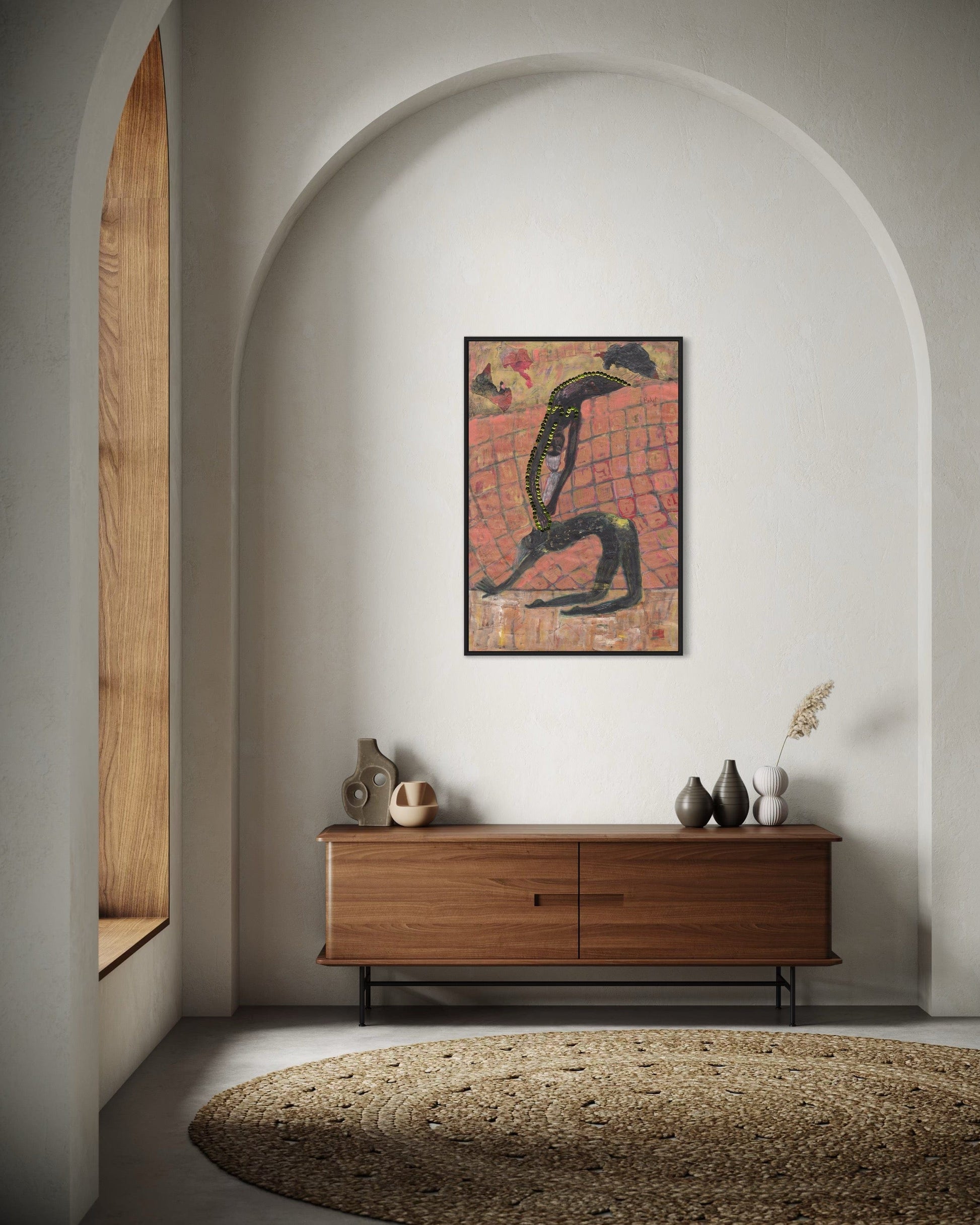 Wooden sideboard with decorative items against a white wall with an arched opening.