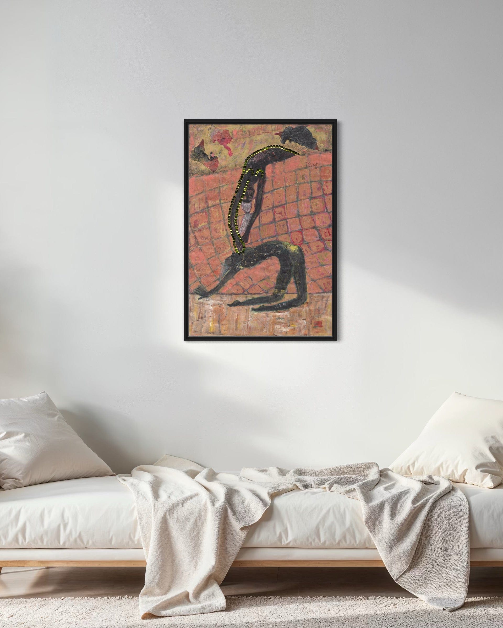 Framed abstract artwork on a wall above a bed