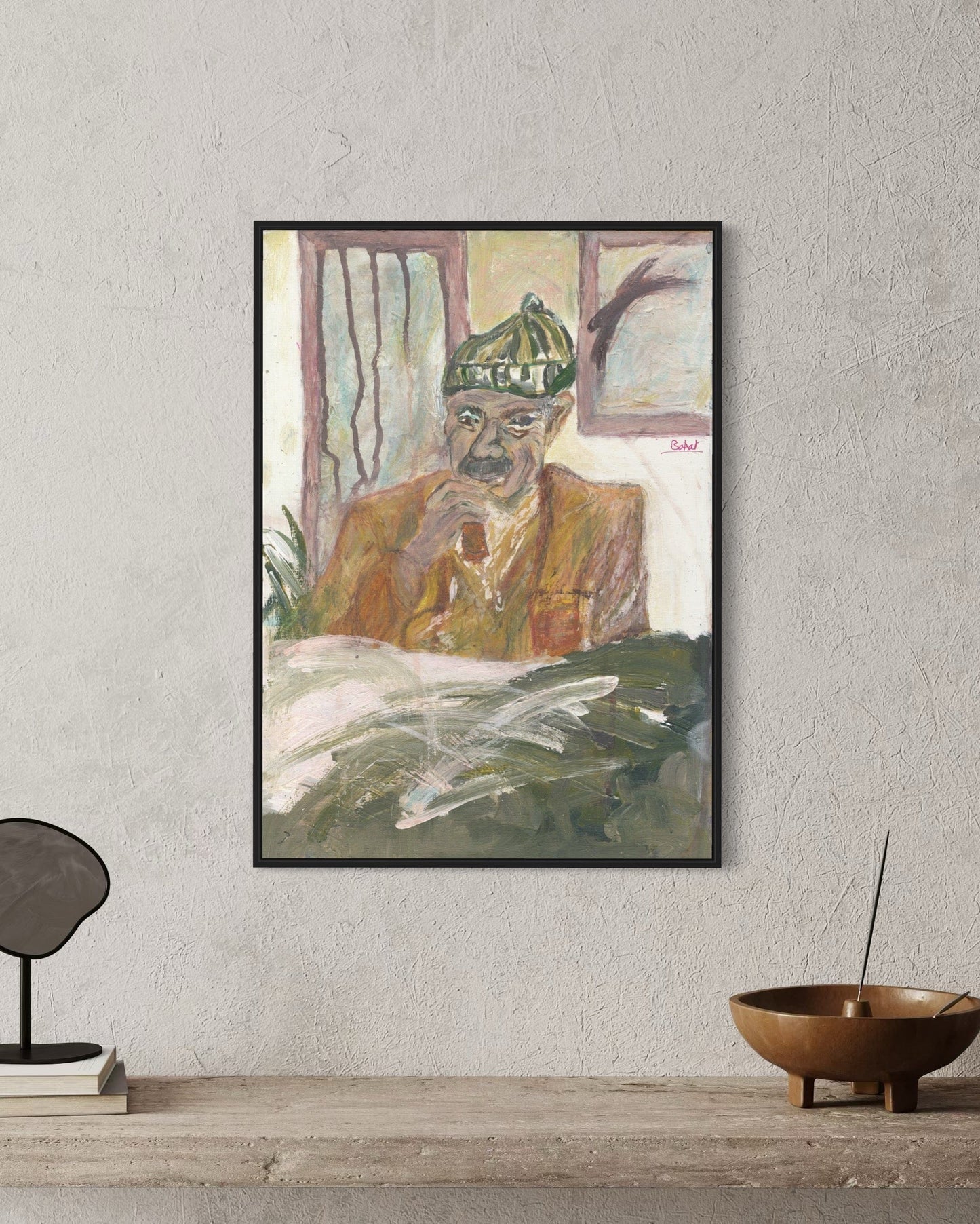 Framed painting of a person with a green hat on a gray wall.