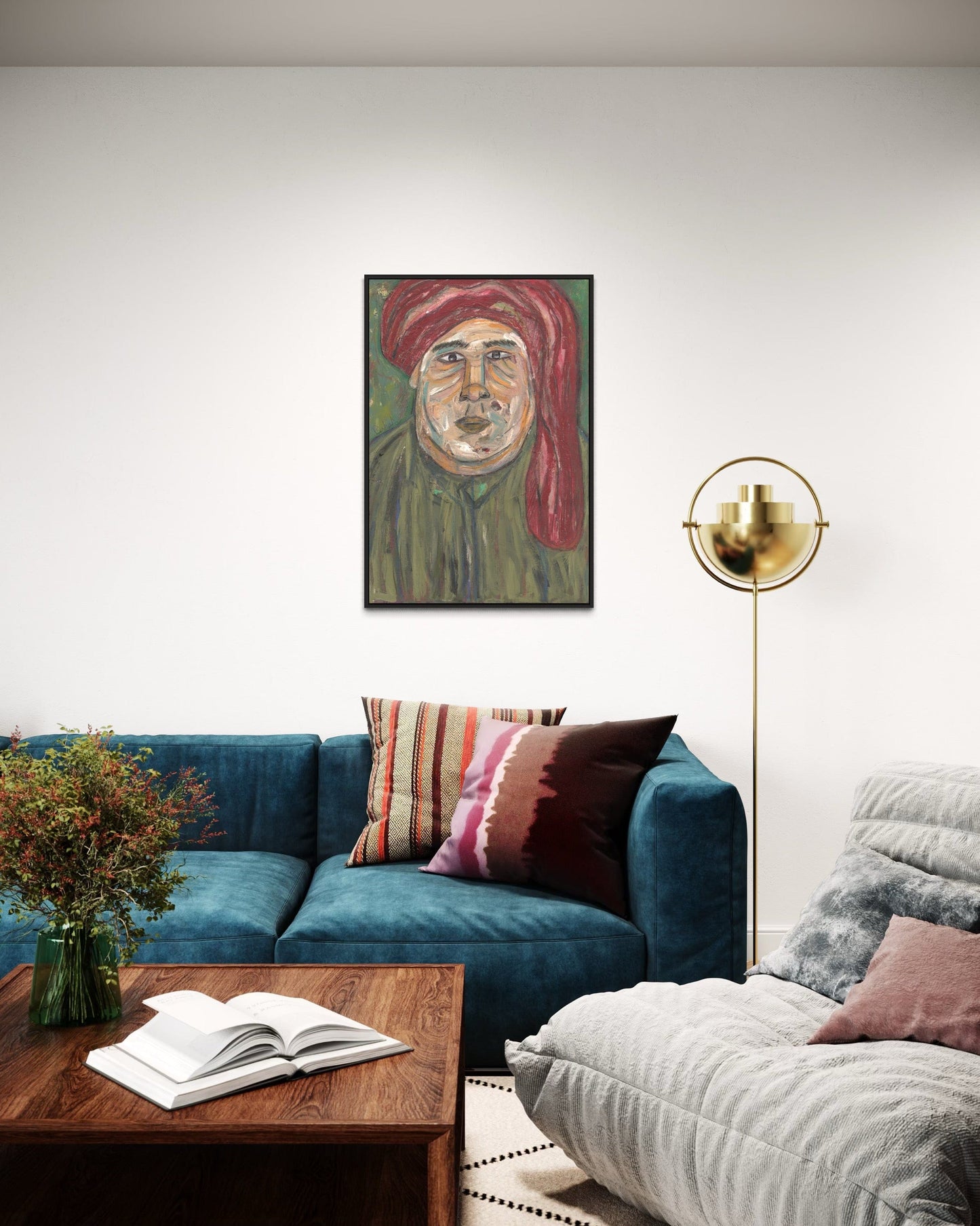 Living room with a blue sofa, wooden coffee table, and a painting of a man in a red turban on the wall.