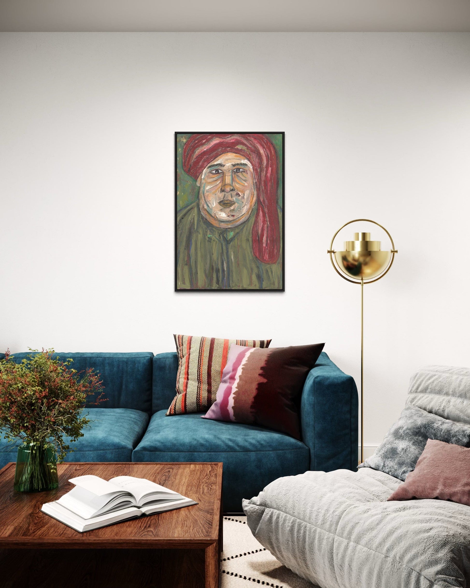 Living room with a blue sofa, wooden coffee table, and a painting of a man in a red turban on the wall.