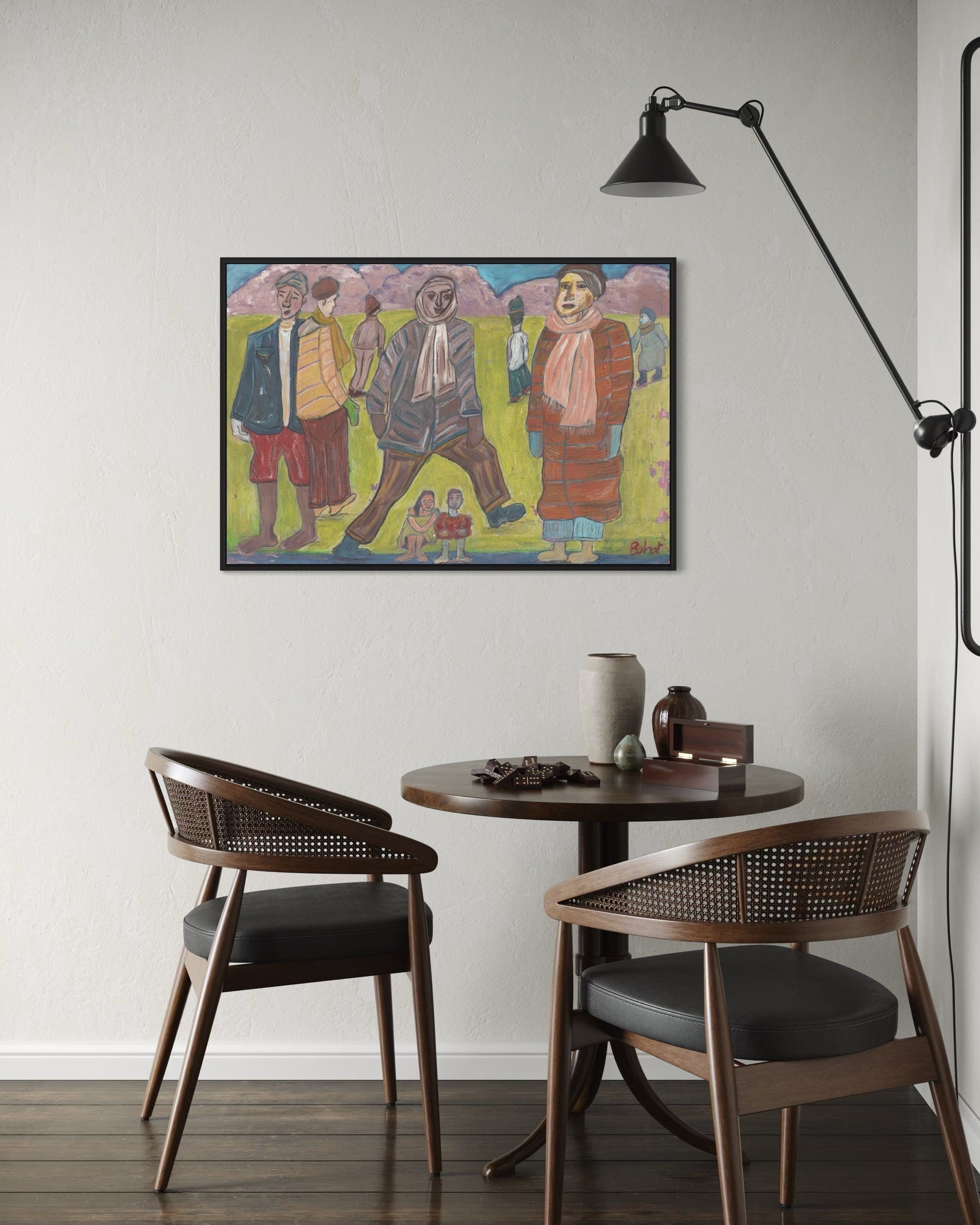 Small dining area with a round table and two chairs, featuring a colorful painting on the wall.