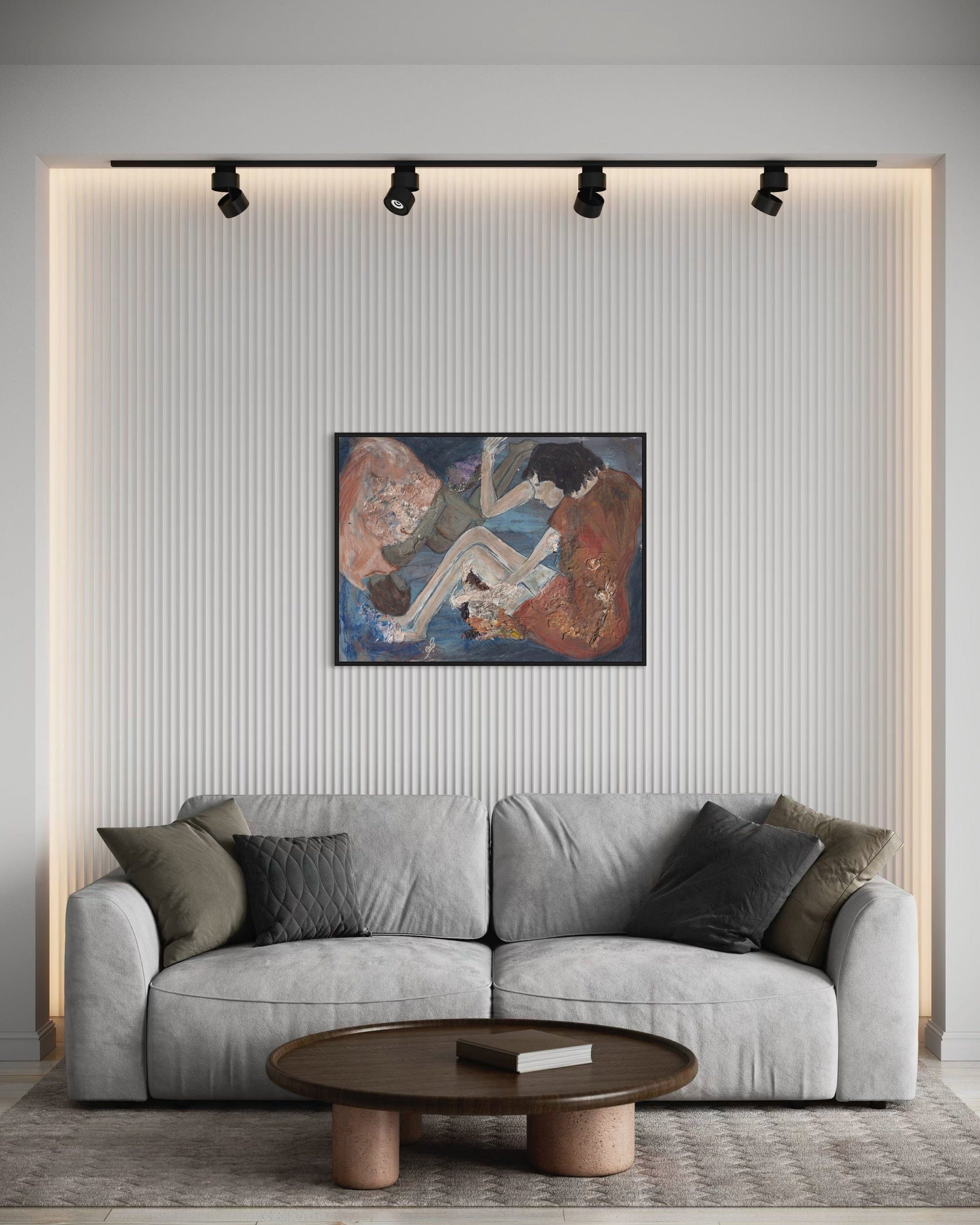 Gray sofa in a living room with a painting on the wall and a wooden coffee table.