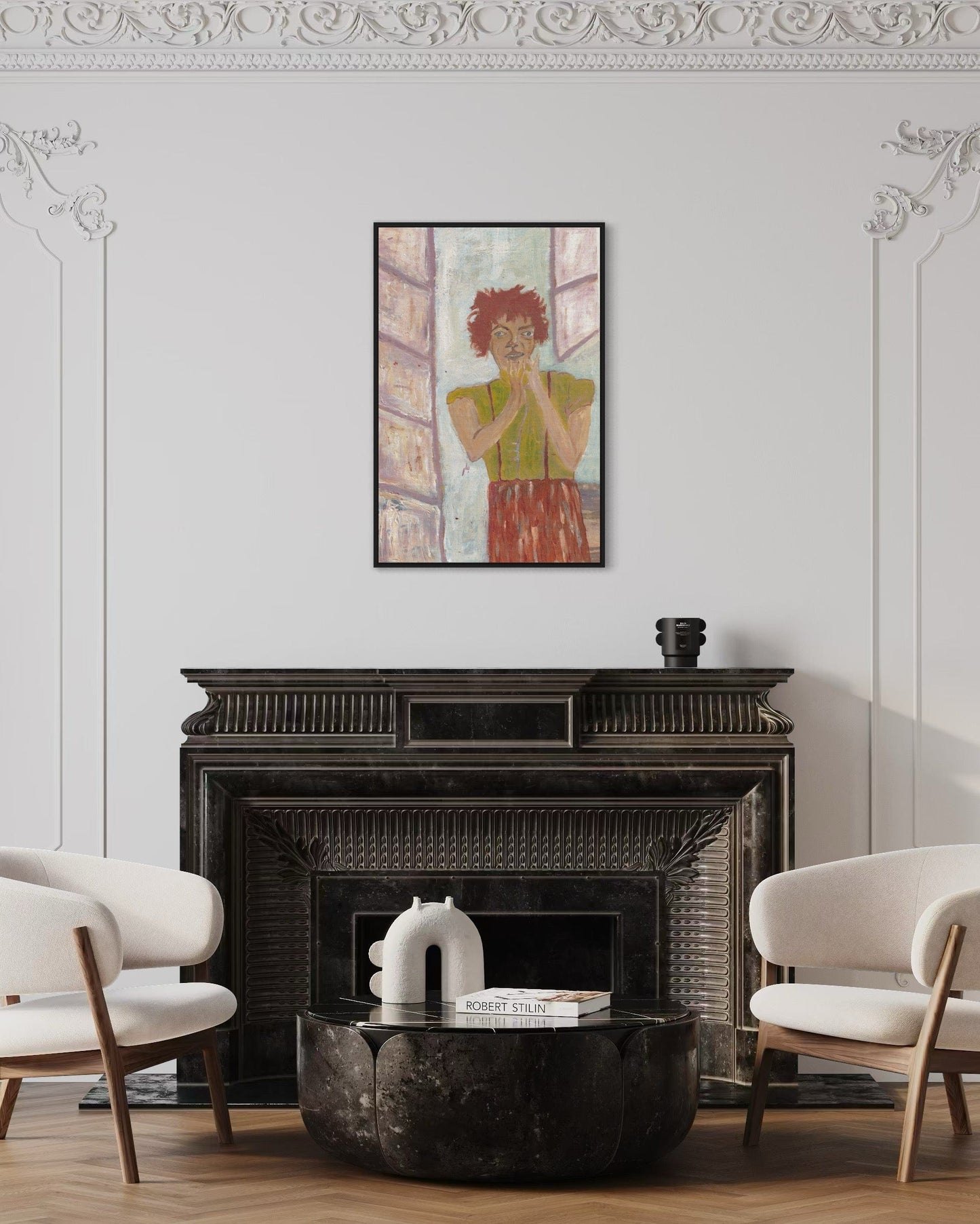 Living room with a fireplace, two chairs, and a framed artwork on the wall.