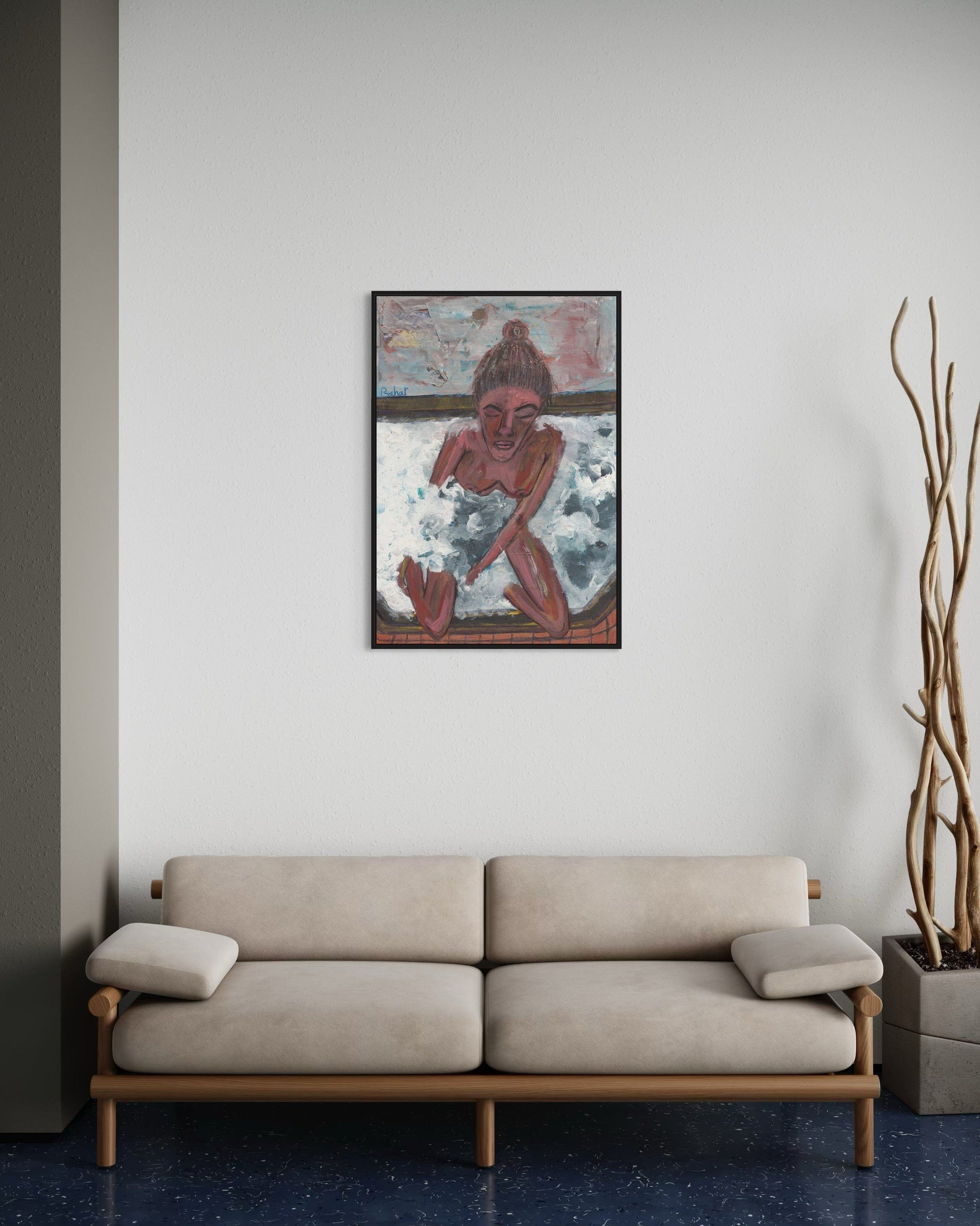 Beige sofa in a room with a framed artwork on the wall and a plant.