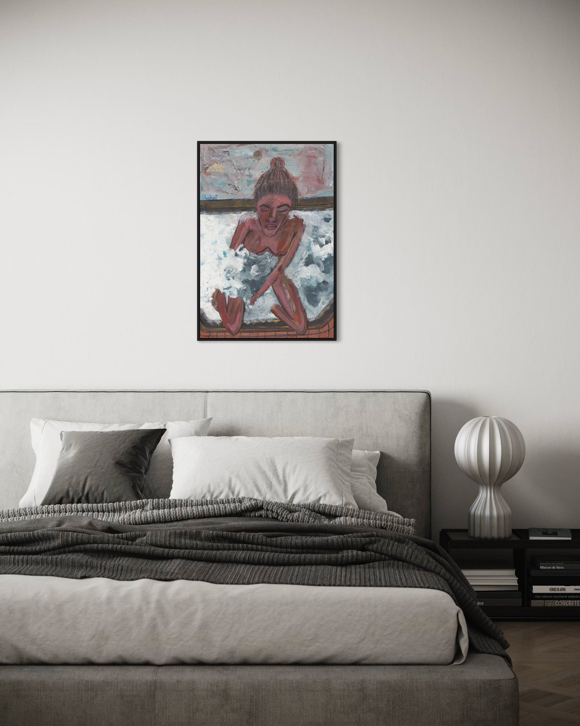 Framed artwork above a bed in a bedroom setting