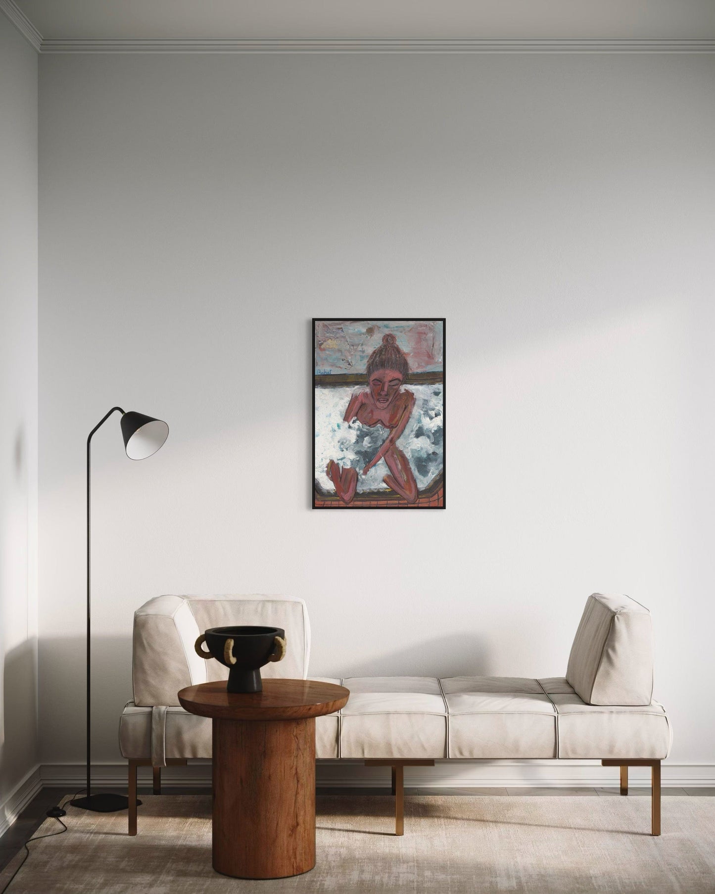 Modern living room with a beige sofa, wooden side table, and abstract painting on the wall.