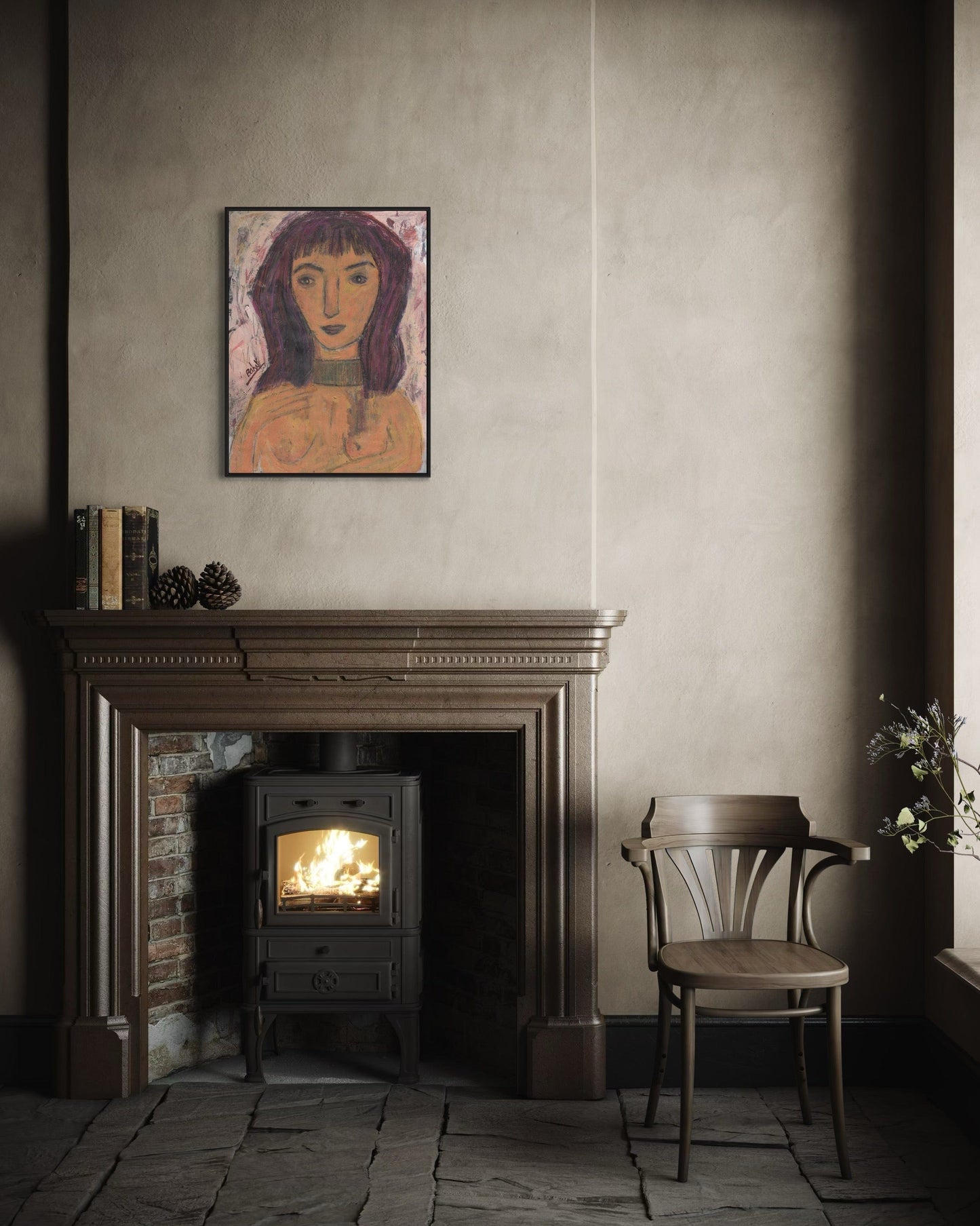 Cozy room with a lit wood stove, chair, and framed artwork on the wall.