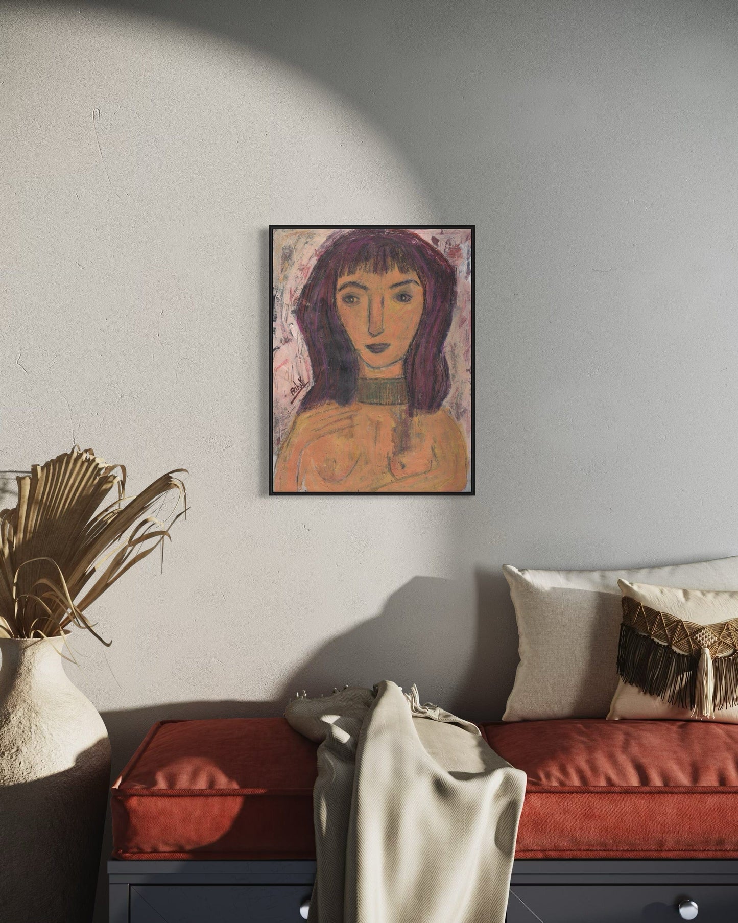 Framed artwork on a wall above a sofa with decorative pillows