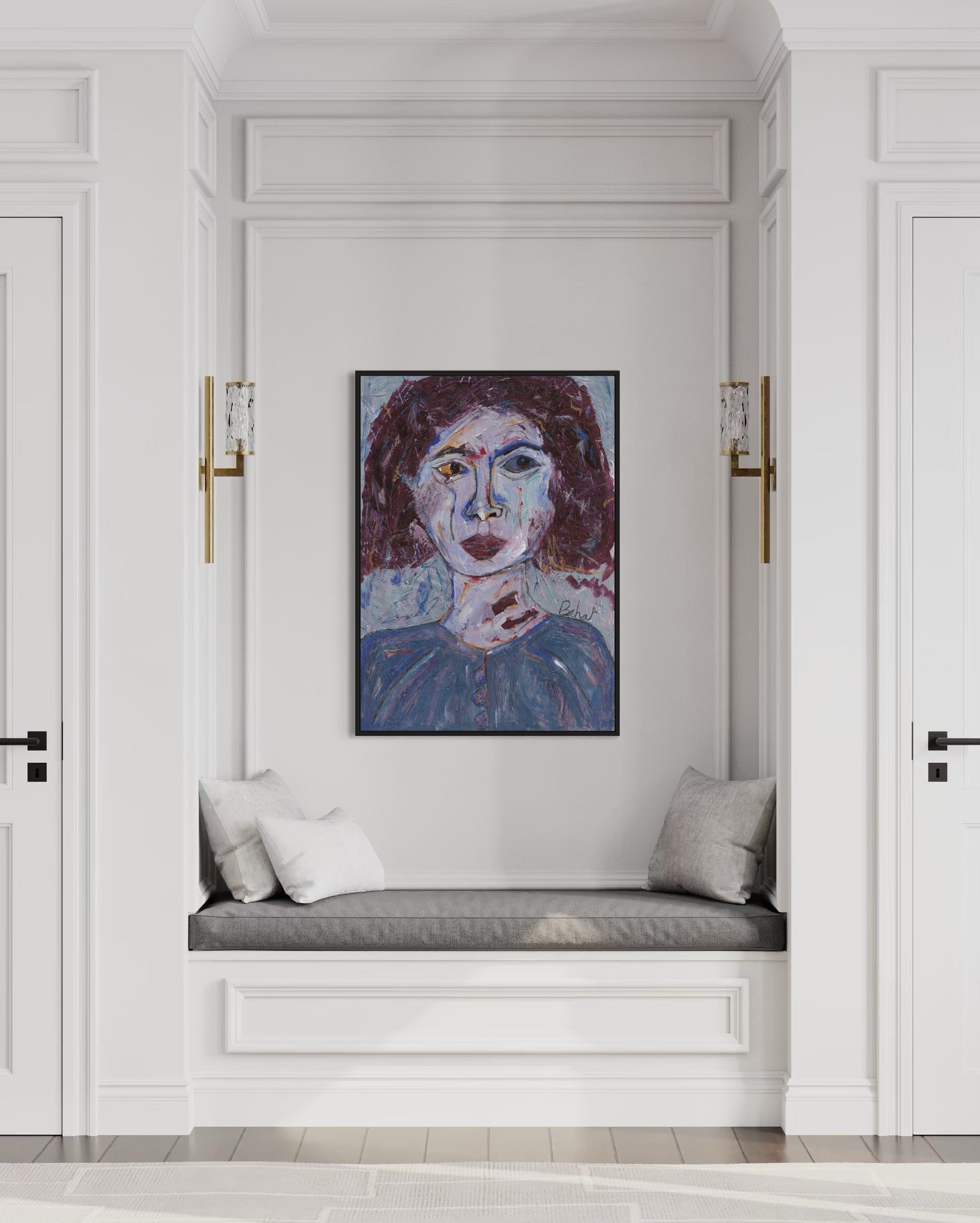 Artistic portrait of a woman on a wall above a cushioned bench in a stylish interior.