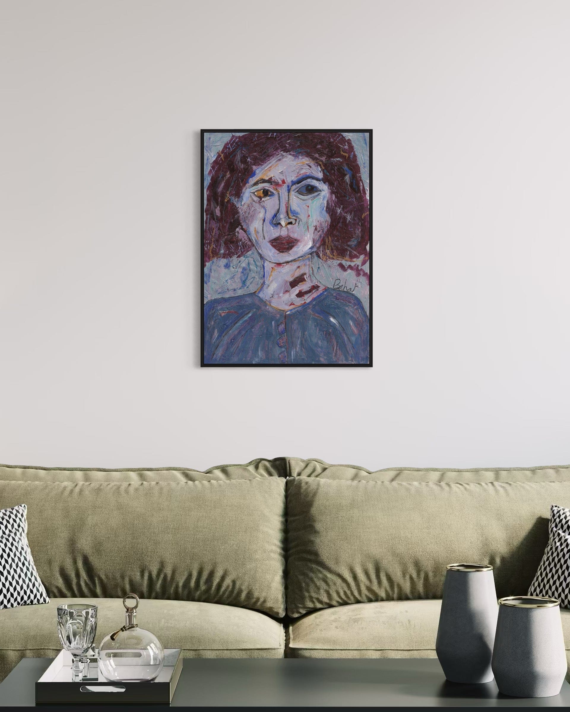 Framed portrait above a beige sofa in a living room setting
