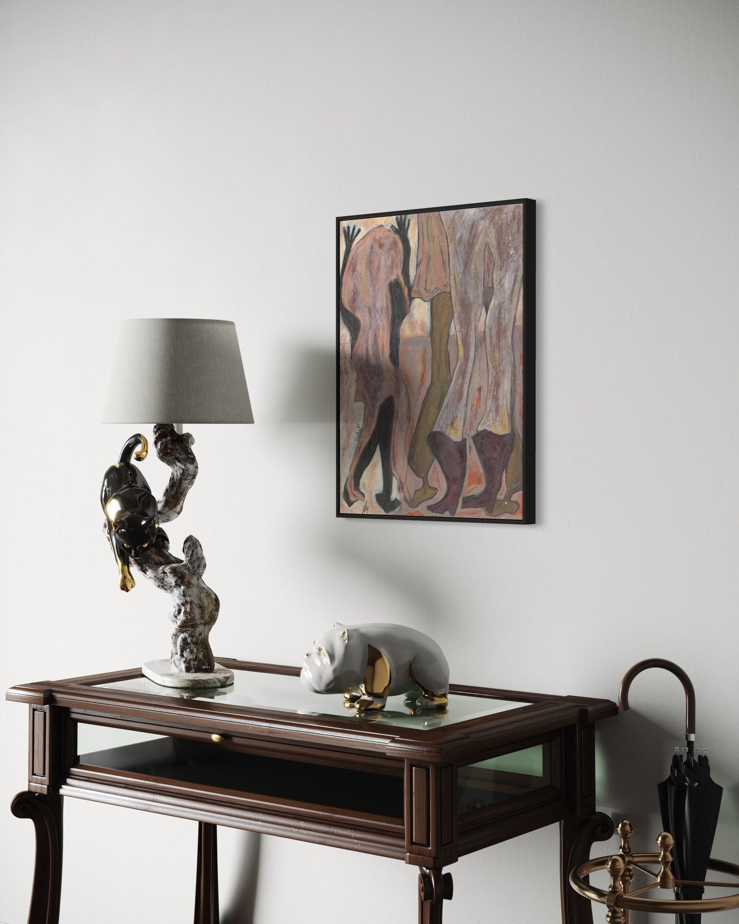 Decorative table with sculptures and a framed abstract painting on a wall.