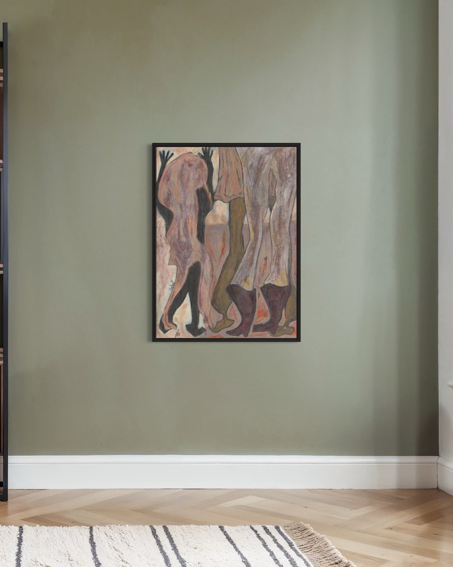 Framed abstract artwork on a green wall with a wooden floor and striped rug.