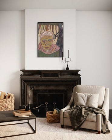 Living room with a fireplace, armchair, and artwork on the wall.