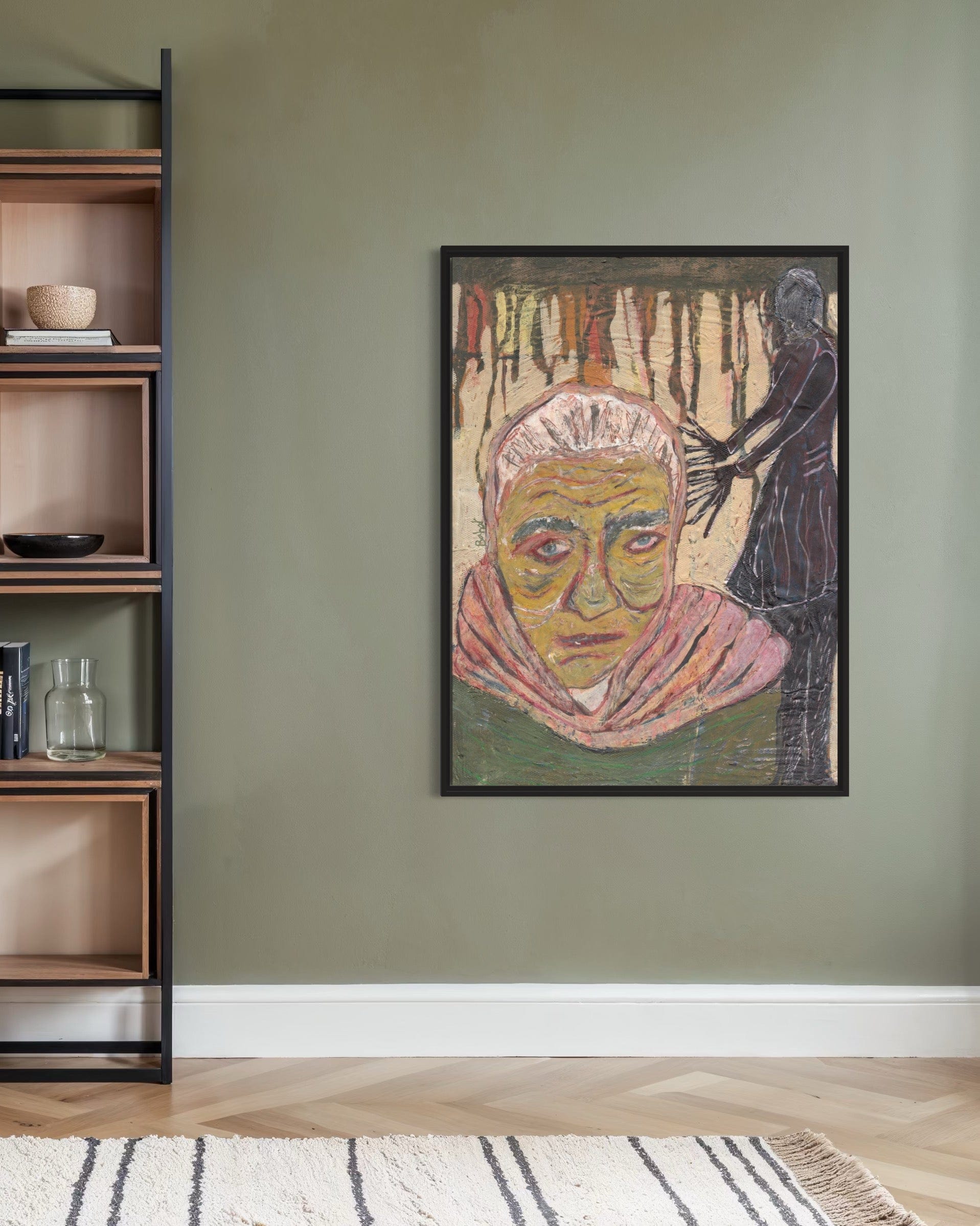 Framed artwork of a woman's portrait on a wall next to a wooden bookshelf.