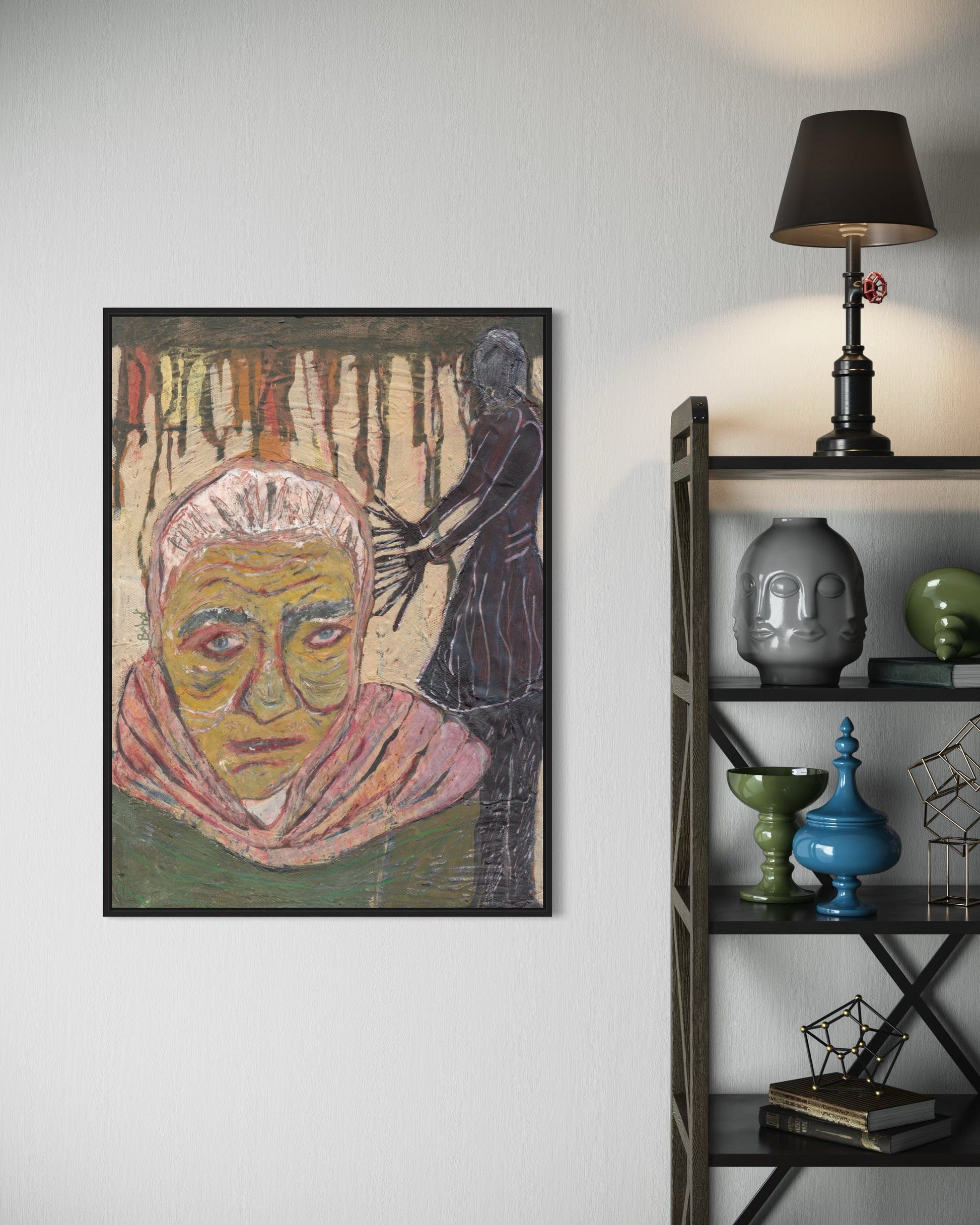 Framed artwork on a wall next to a bookshelf with decorative items