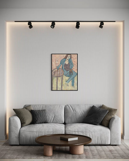 Gray sofa in a living room with a wall painting and round wooden coffee table.