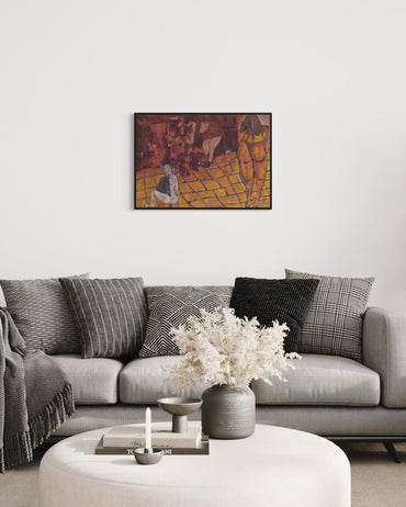Living room with a gray sofa, decorative pillows, a vase with flowers, and a framed painting on the wall.